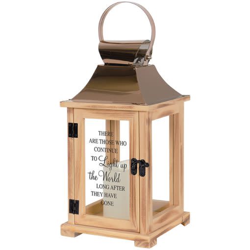 "Light Up The World" "Light Up The World" - This lantern is made from quality wood and a stainless steel copper finish top. It features a built-in automatic timer which runs for 6 hours on and 18 hours off(3-AAA batteries are NOT included) and is uv printed with a sentimental quote. DO NOT use fire burning candles in the lantern. Suitable for hanging or free-standing use inside. Recommended as an accent in floral arrangements for many occasions! W: 6.25" H: 13.5" D: 6.25"