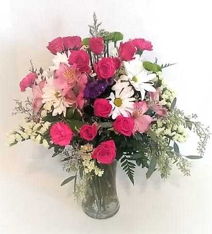 Showers of Flowers Showers of Flowers - Shower them with an assortment of spray roses, long lasting daisies and alstromeria, statice and assorted greenery in a clear vase.