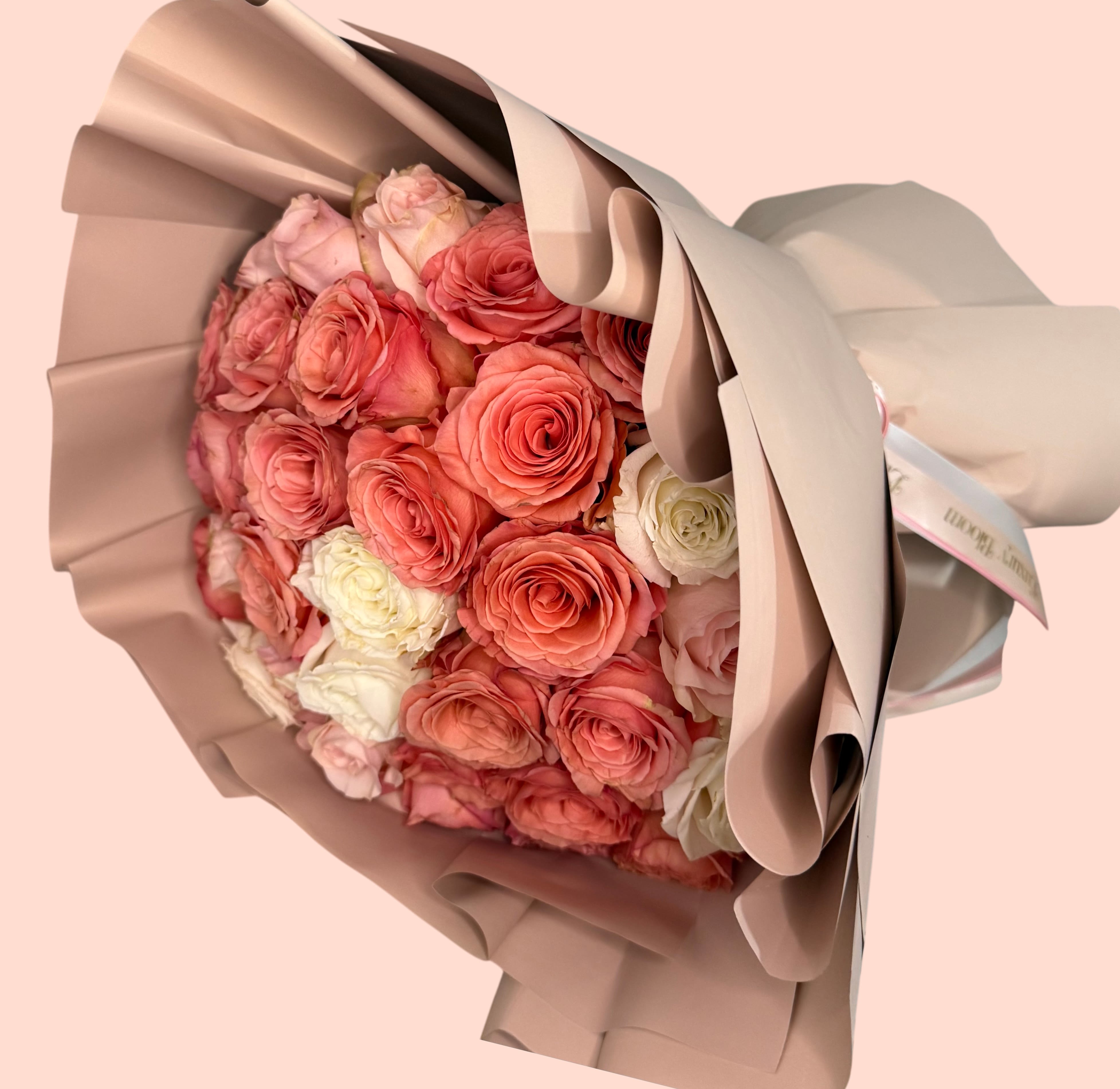 Coral Chic Bouquet  - Standard - 48-50 roses Deluxe - 73-75 roses Premium- 99-100 roses  A sophisticated arrangement featuring roses in coral, ivory, and soft blush tones. Each bloom is carefully selected to create a harmonious design that evokes sweetness, romance, and elegance. Perfect for special moments or simply to say “you’re on my mind.