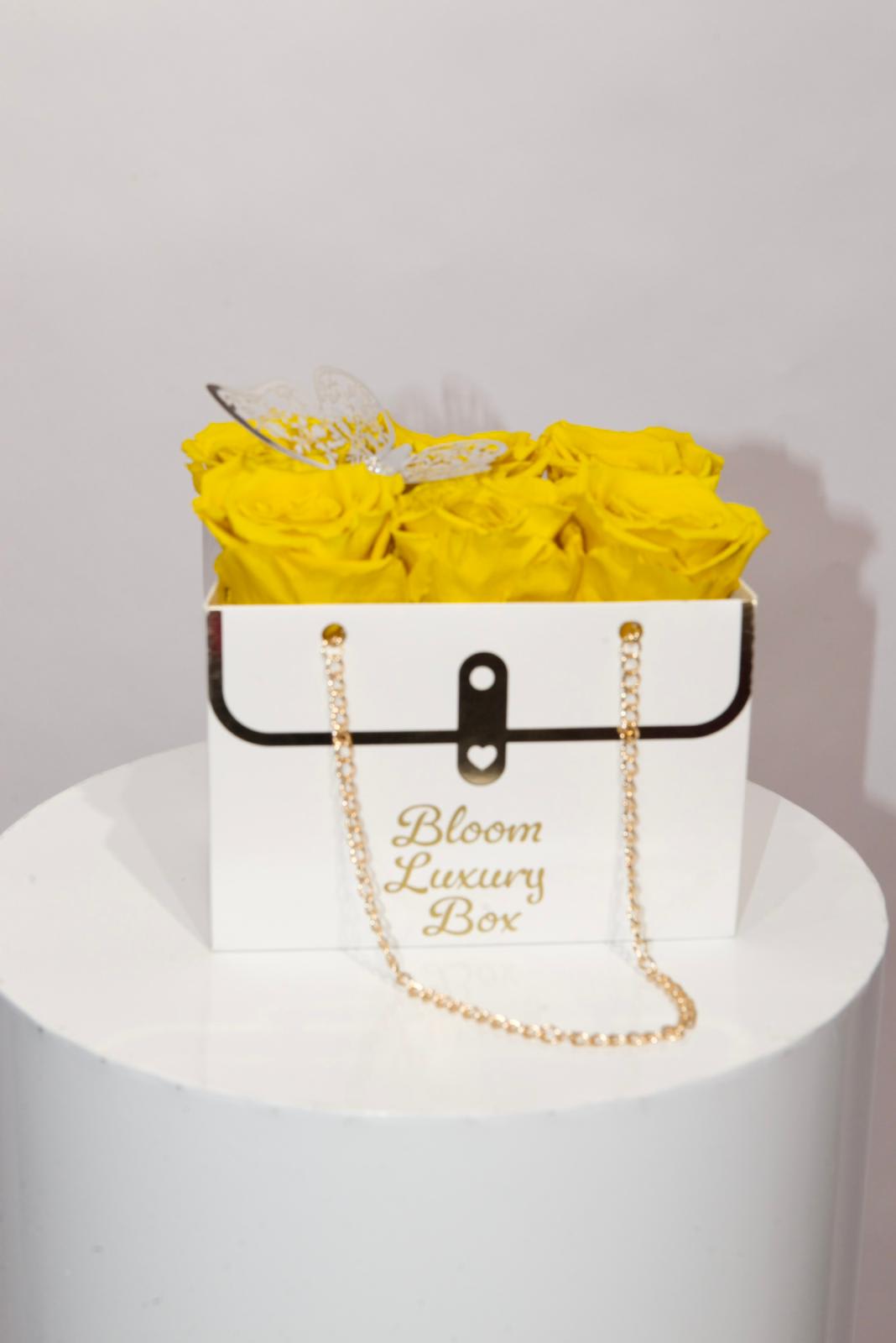 Yellow  roses in a purse  - Yellow natural roses in a purse topped off with a butterfly
