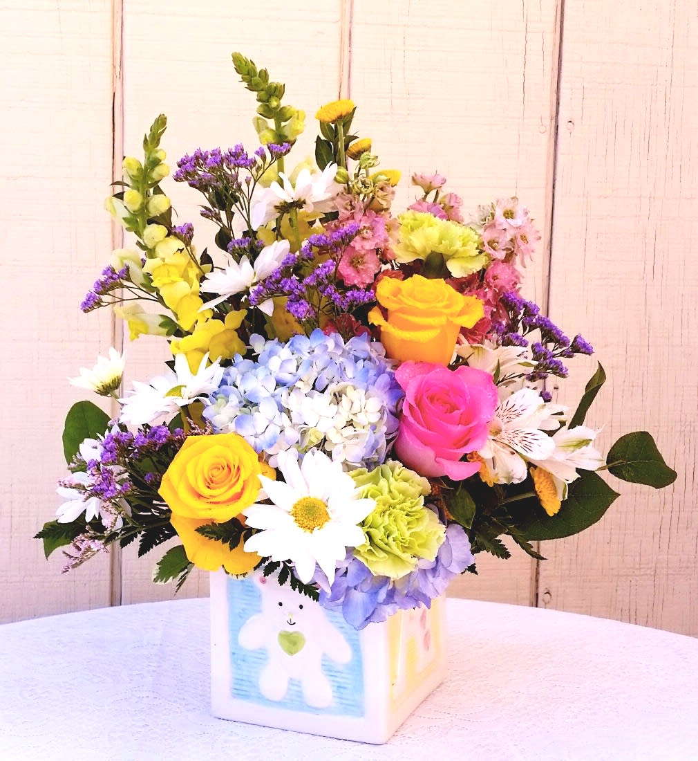 Brand New baby! Brand New baby! - Spring flowers welcome baby with a beautiful arrangement of Roses, Hydrangea, Snapdragons and daisies in a ceramic keepsake ceramic cube