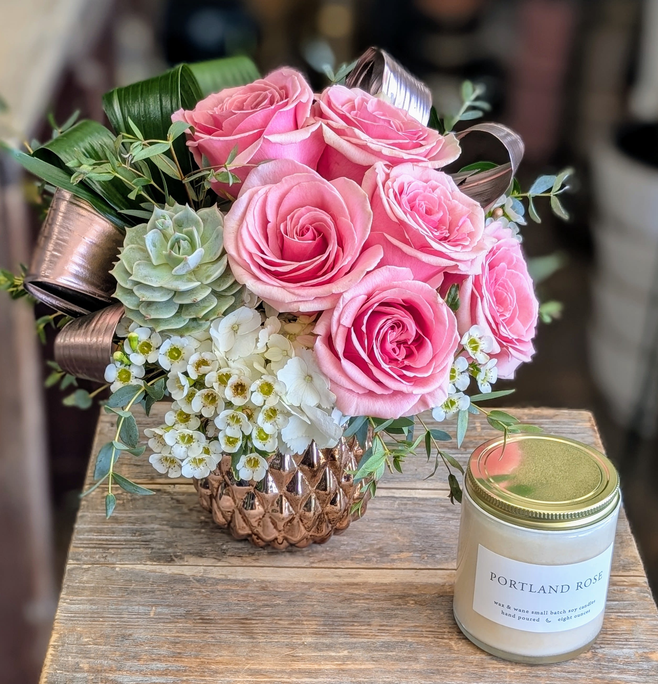 Rosetta- Includes A Portland Rose Soy Candle Rosetta- Includes A Portland Rose Soy Candle - Rosetta Elegant, romantic, and timeless—Rosetta is a graceful floral arrangement from Windmill Floral Expressions in Las Vegas, designed to speak the language of love in soft, luxurious tones. A delicate blend of blush roses unfurls like a whisper, complemented by creamy hydrangeas and accented with wisps of greenery that add texture and movement. Arranged in a vintage-style ceramic vessel, Rosetta evokes the charm of handwritten letters and antique beauty, making it perfect for anniversaries, sympathy, or moments that call for quiet elegance. Its gentle palette and refined composition bring warmth and grace to any setting. Luxury Floral Arrangements in Las Vegas – Romantic, Handcrafted Bouquets from Windmill Floral Expressions.This arranged is accompanied by a Portland Rose 8oz soy candle.