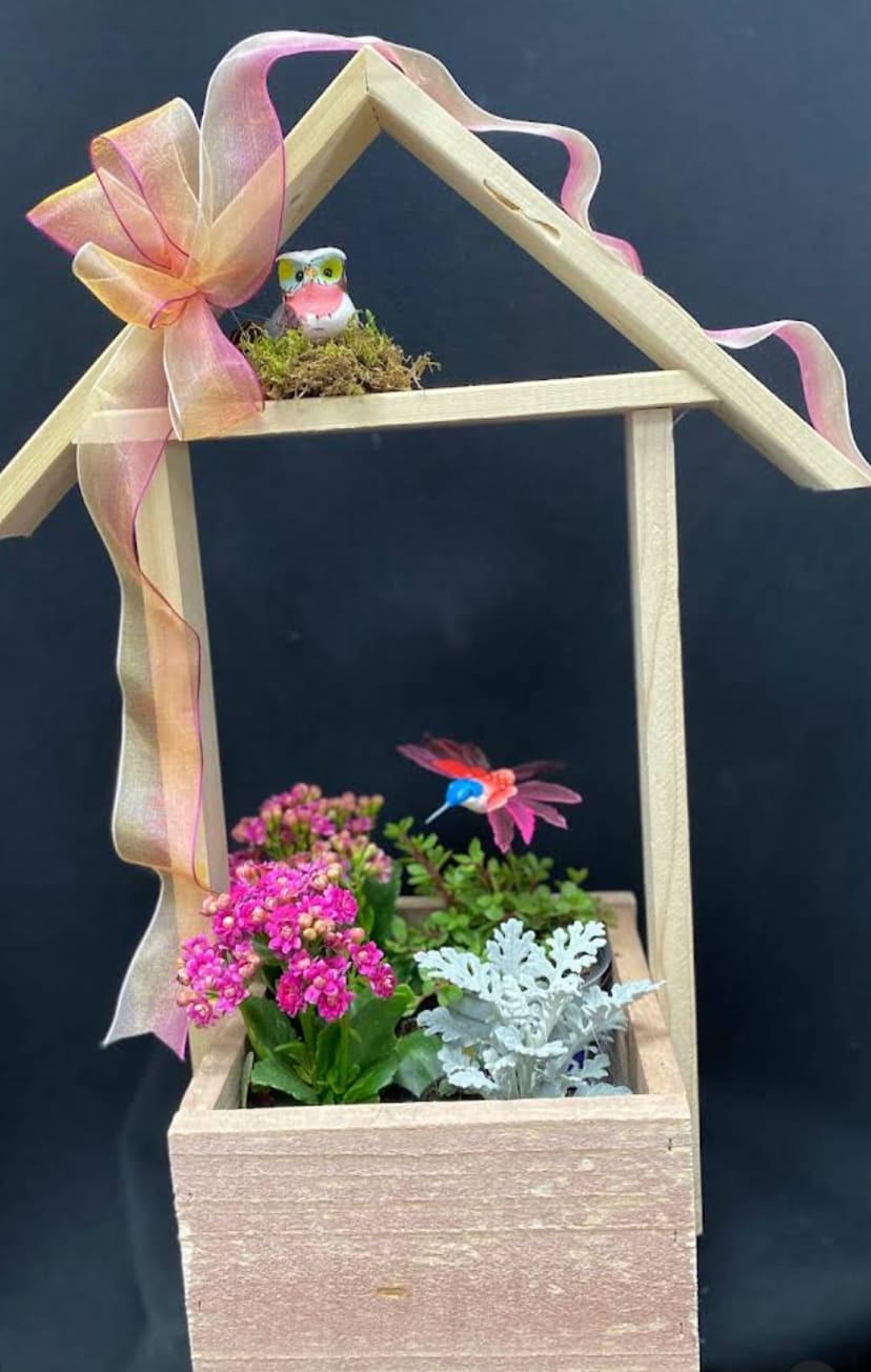 My house is your house - Wooden birdhouse with planter, blooming and green plants decorated with hummingbird and nested owl and ribbon