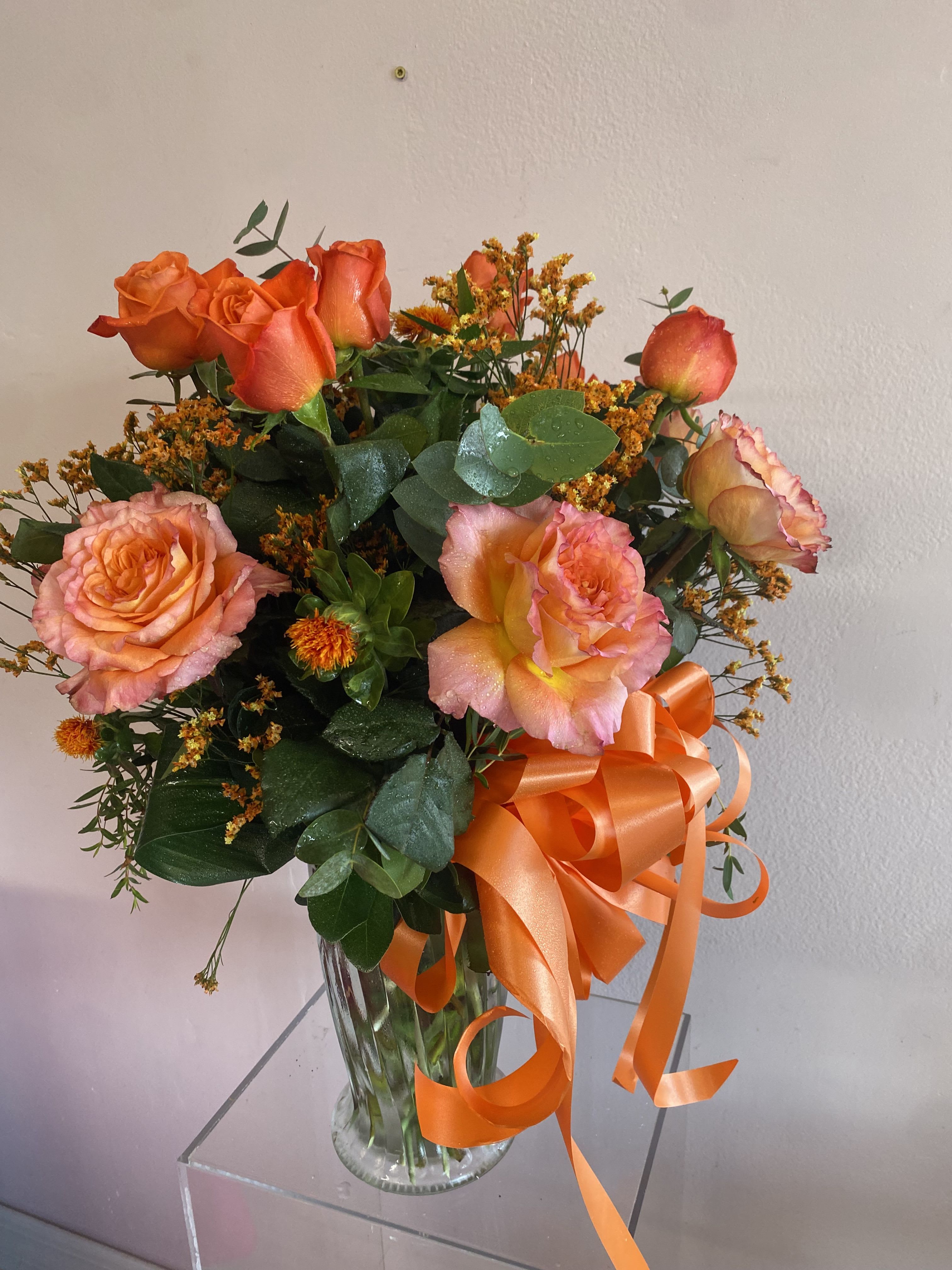 Orange Crush - Orange garden roses accent with regular roses and seasonal orange flowers.