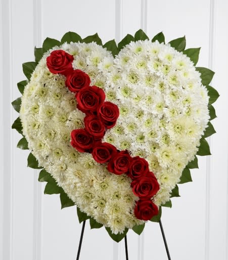 Tribute Heart Flower Easel Tribute Heart Flower Easel - To express just how you feel, send this heart-shaped flower arrangement with its white chrysanthemums and red carnations. Each heart is covered with white chrysanthemums, accented with a cluster of red carnations and edged in oregonia. The flower heart is delivered on an easel.