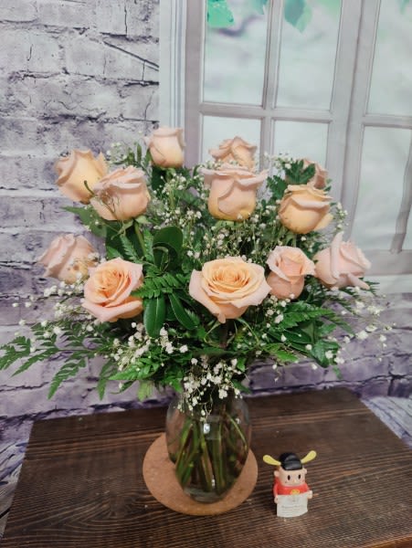 The Peach Roses Bouquet The Peach Roses Bouquet - Soft and elegant, our Peach Roses Bouquet features beautiful peach roses arranged in a vase with fresh greenery and delicate baby's breath. A lovely choice to convey warmth and appreciation. The STANDARD version includes 12 roses. The DELUXE version includes 18 roses. The PREMIUM version includes 24 roses.