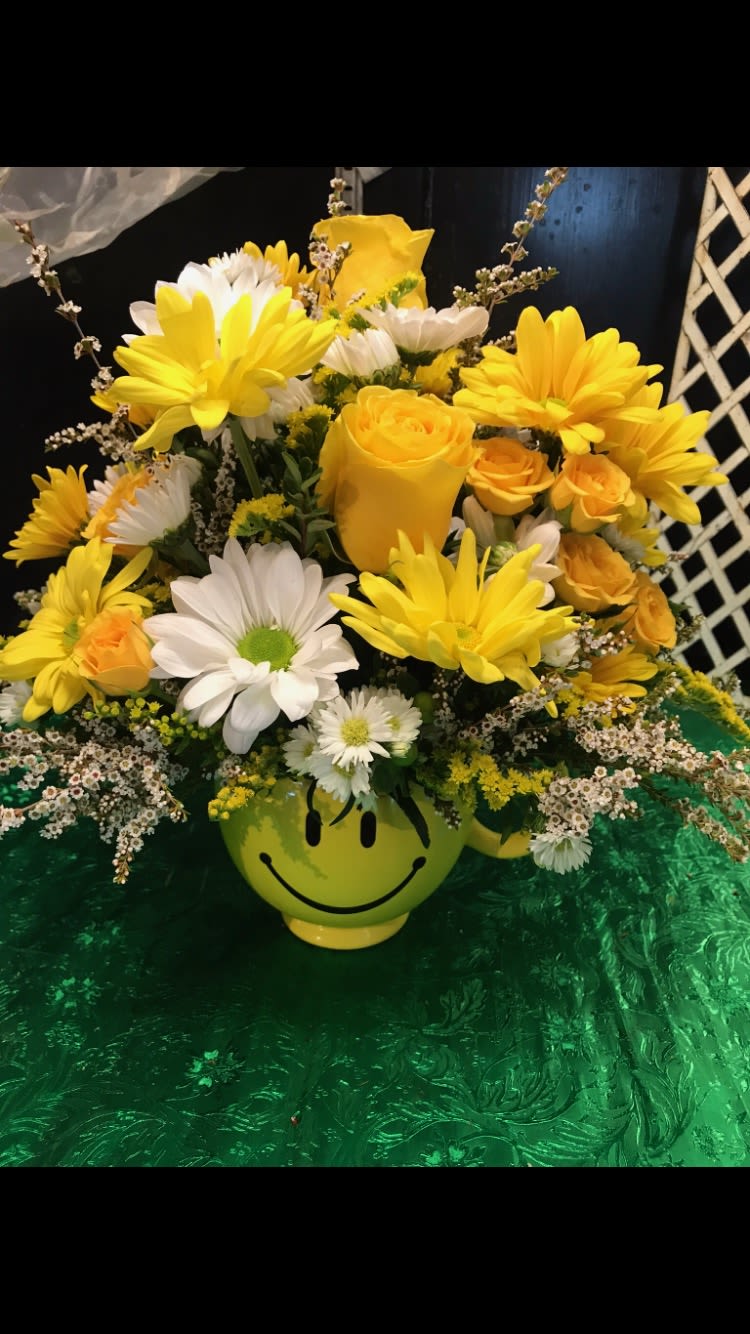 Smiley Smiley - in a yellow and white daisies with yellow roses and spray roses in a smiley cup