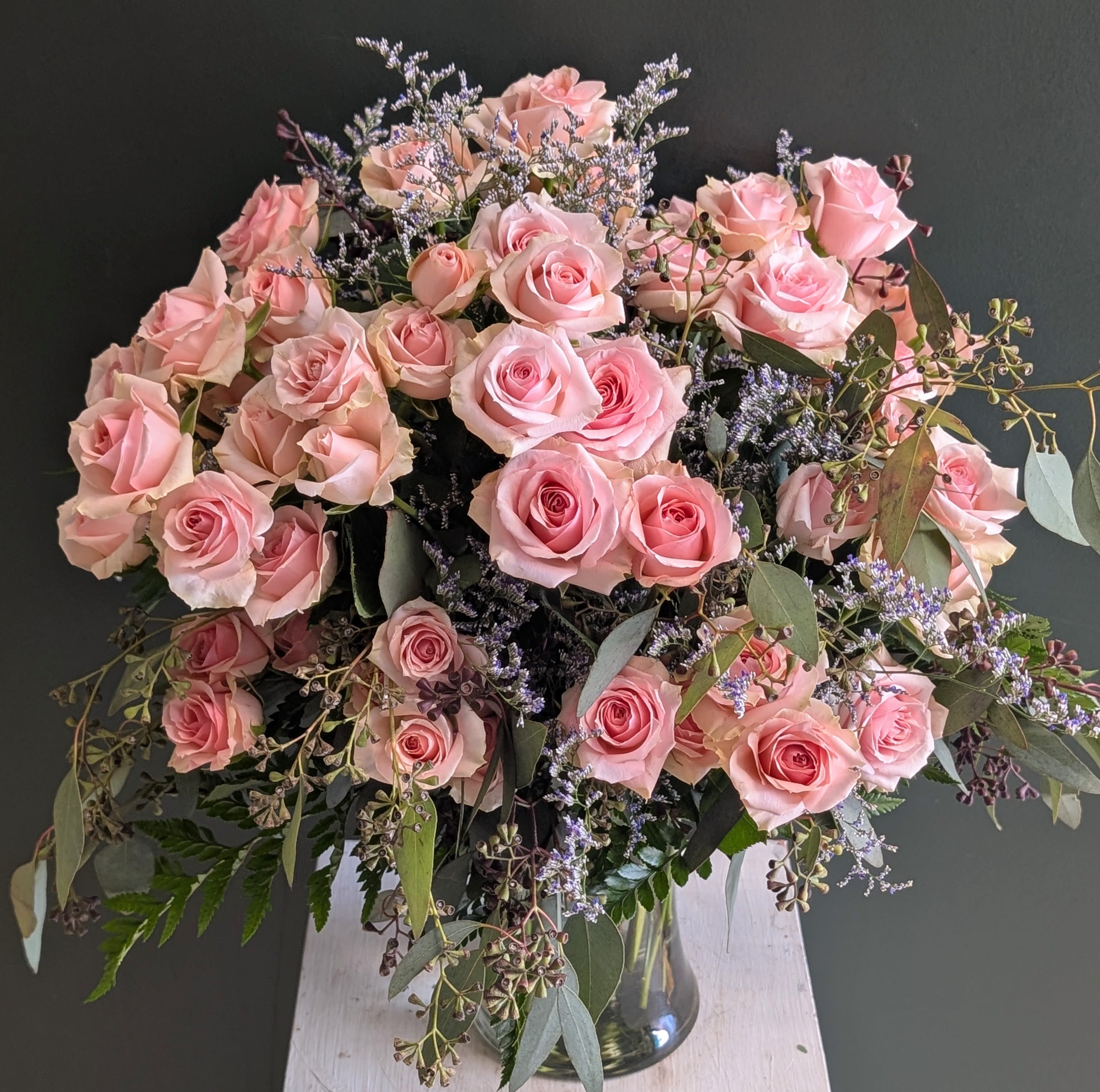 Romance and Riches  - This is what two dozen pink spray roses in a vase looks like (that is roughly 120 blooms!) . It is much more beautiful than a simple dozen roses. So much more complex and interesting. So much more romance and lush richness. Lets send this! 