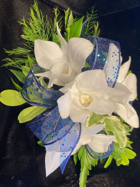 Navy Blue and White Orchid Wrist Corsage Navy Blue and White Orchid Wrist Corsage - The classic white orchid corsage with a touch of sparkle.