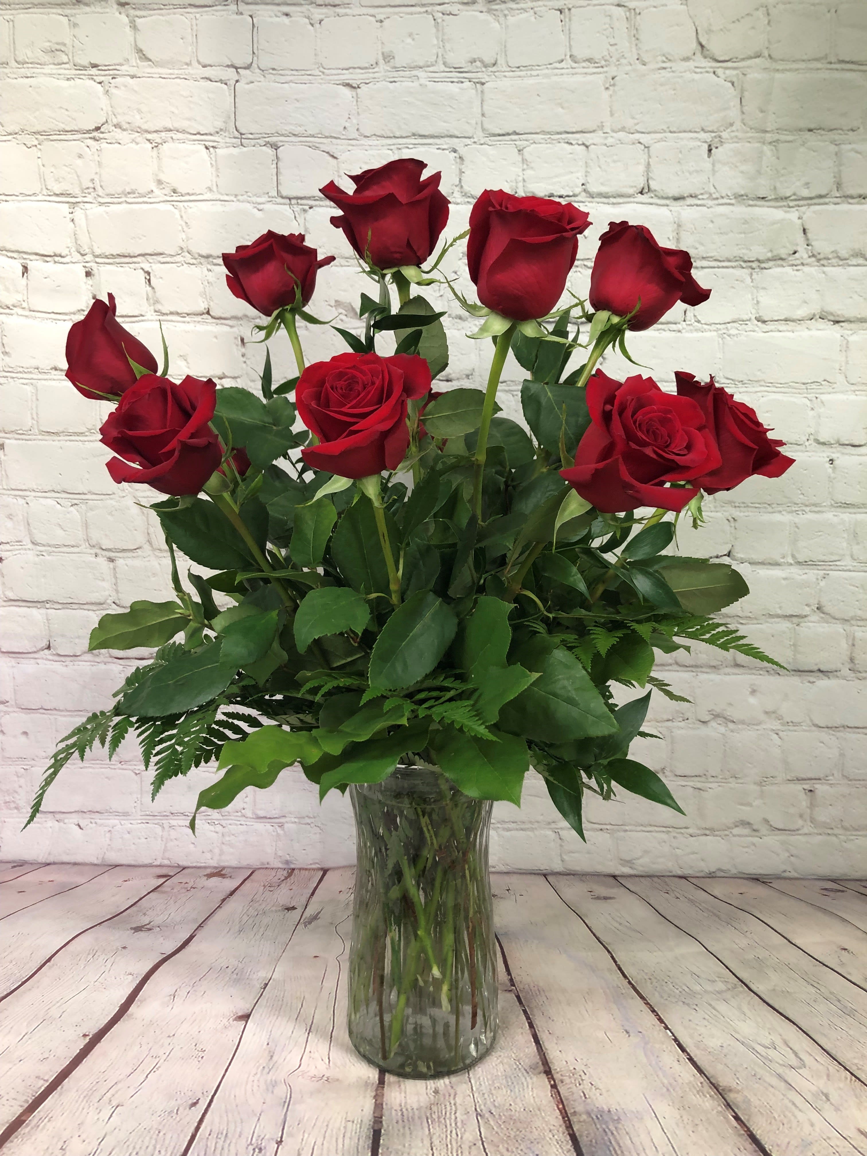 The Perfect Dozen - A dozen roses are always perfect, always savored. We add even more charming beauty with seeded eucalyptus, spiral eucalyptus and salal. Please specify what color roses you desire! We know not everyone wants red! We have multiple different colors and types!  *Container and Flowers may differ slightly from what is shown in the picture depending on availability and season