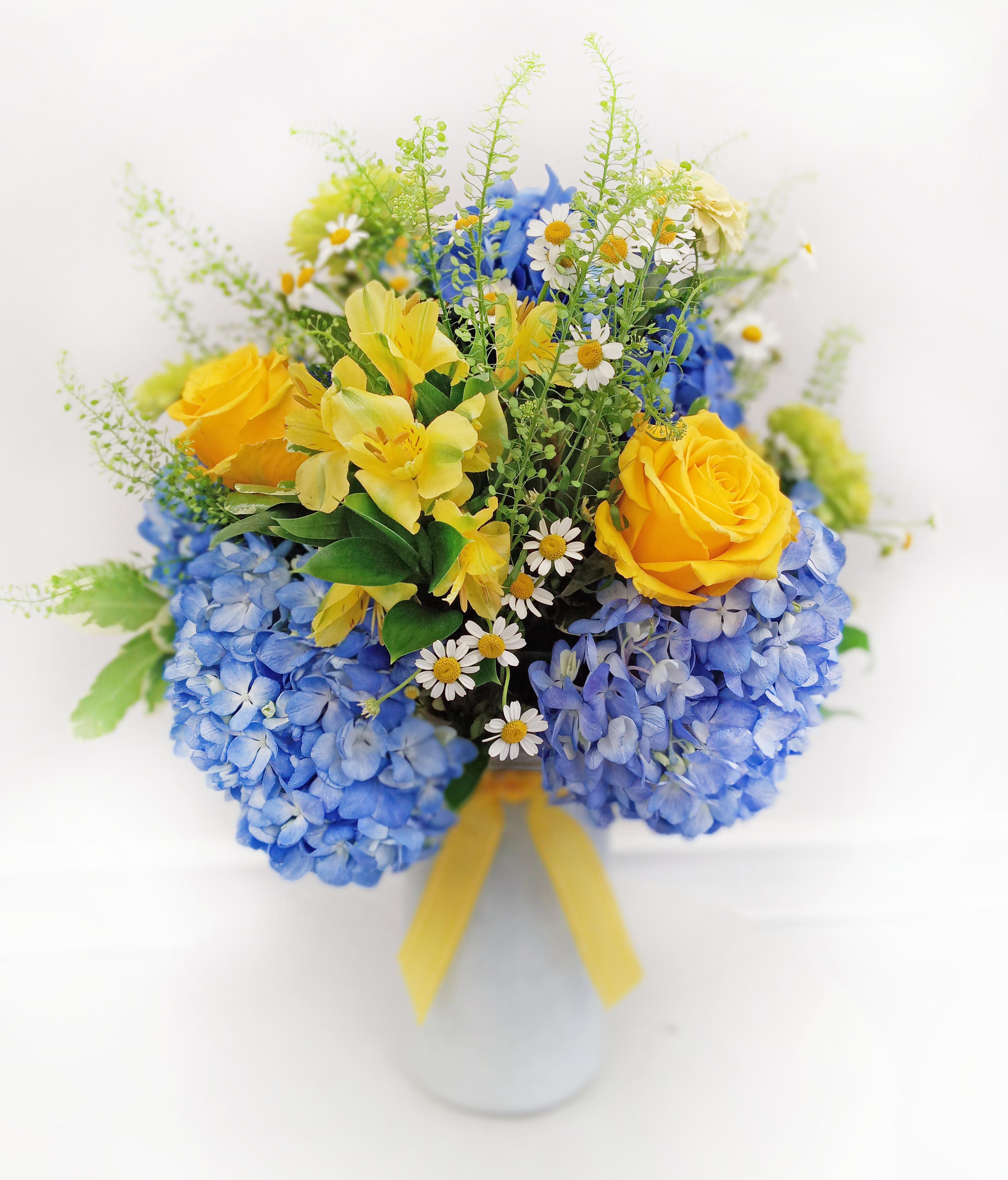 Summer Blues Summer Blues - A blue hydrangea arrangement is beautiful anytime of year. Change the pop of yellow shown in sample picture to your favorite color! Flowers and vase may vary in color depending on availability.