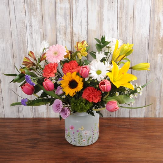 Wild Child Wild Child - A unique floral vase filled with bright blooms. Shades of orange, pink, yellow, purple and white accents.