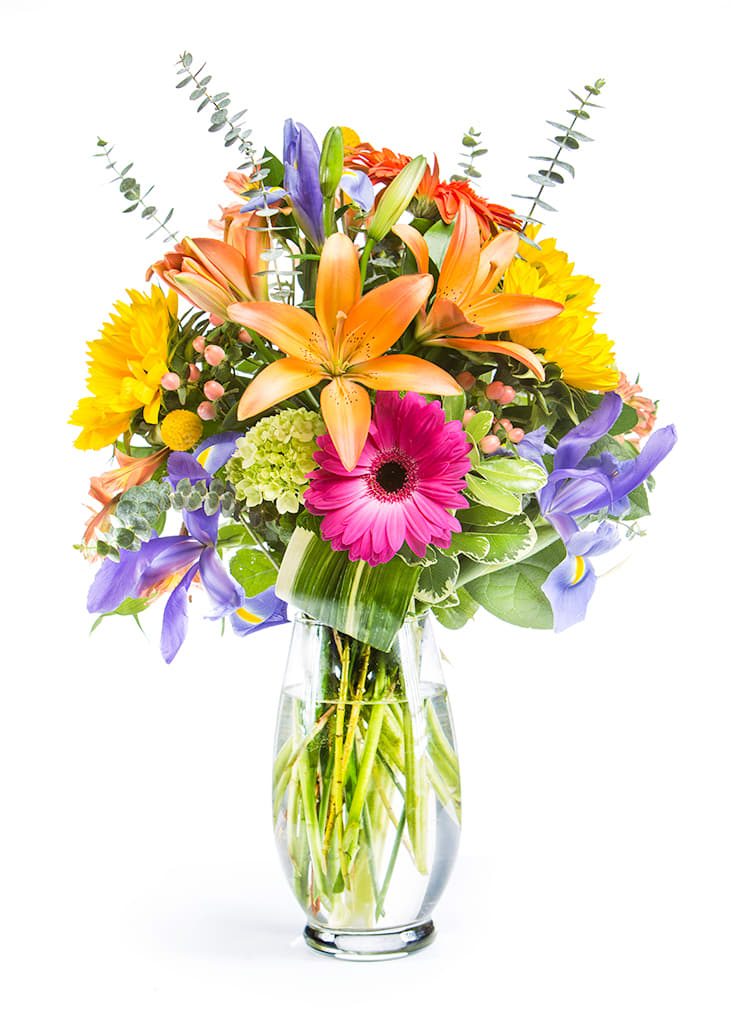 Sunny Summers Day - A festive and colorful blend of summertime's finest blooms, in a classic clear vase. Designed in a vase and delivered by us, a real Portland florist to anywhere in the greater Portland Oregon area. Place your order online, or call us directly 503 223 1646