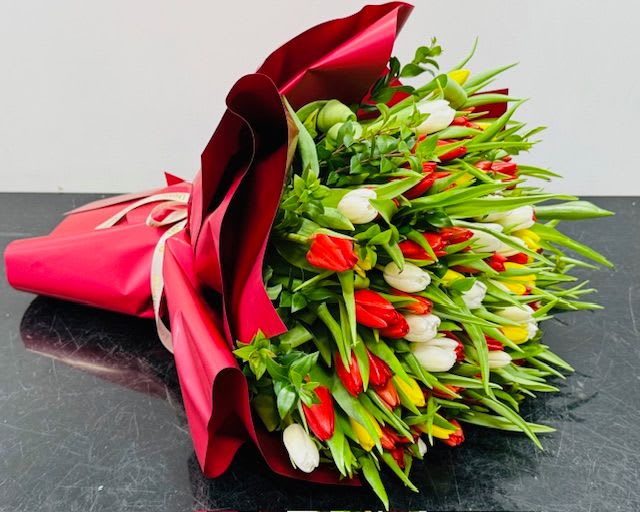 Tulip Garden Tulip Garden - Mixed bouquet of red, white and yellow fresh tulips, with exposed green stems. Hand wrapped to perfection. Great for all occasions Some florals are seasonal, if particular flower will not be available due to season, we will substitute for similar flower, composition, color pallet and value of the arrangements as closely as possible. All effort to create a floral arrangement as close to the photo shown, the actual arrangement may vary slightly in its appearance from the photo shown. If you have any questions about your order, we welcome you to call us or email.