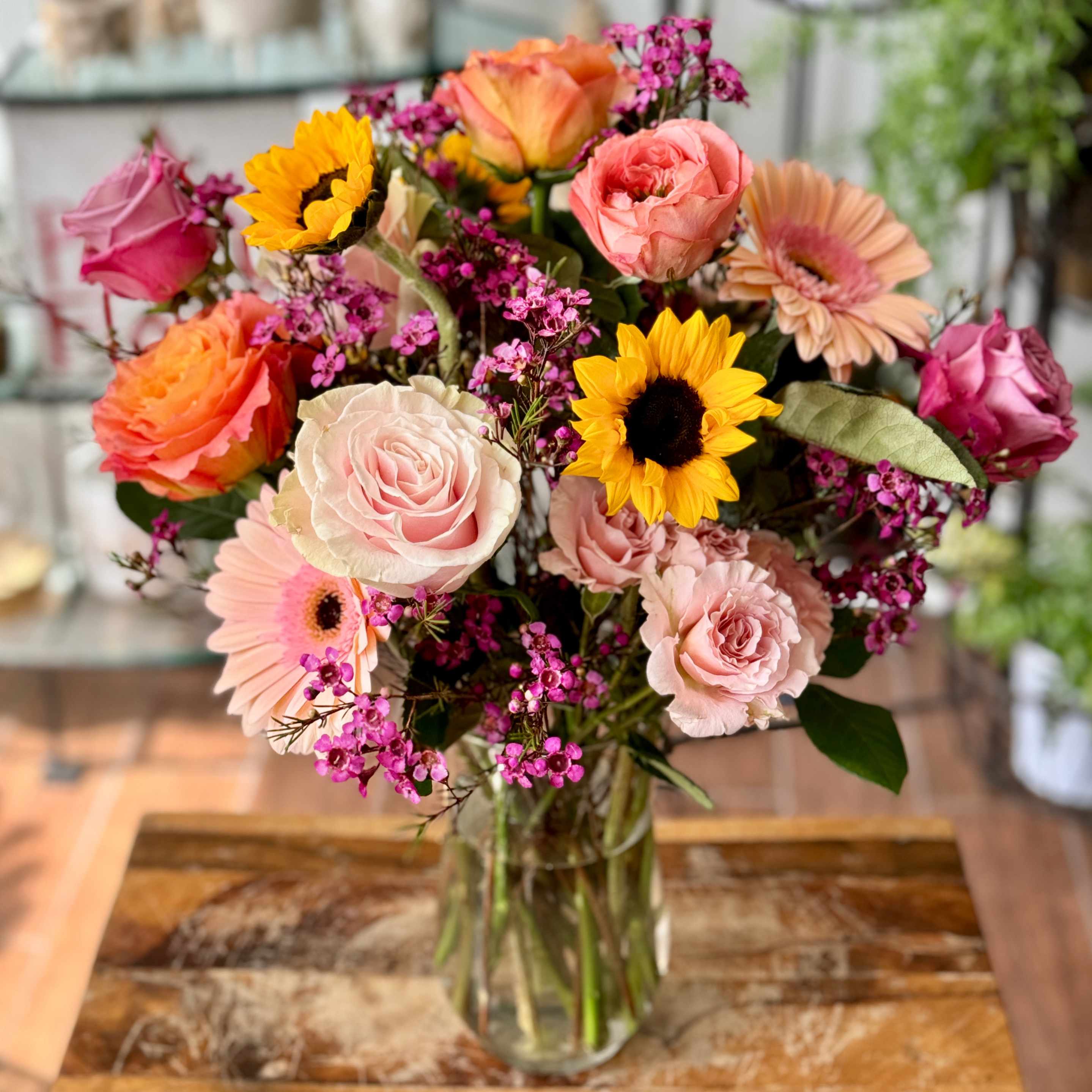 Catie (Pet Friendly)  - Catie is a cat friendly arrangement! It will consist of wax flowers, limonium, gerbera daisies, roses, spray roses and sunflowers, depending on availability of flowers. COLORS will have variation depending on availability of flowers.