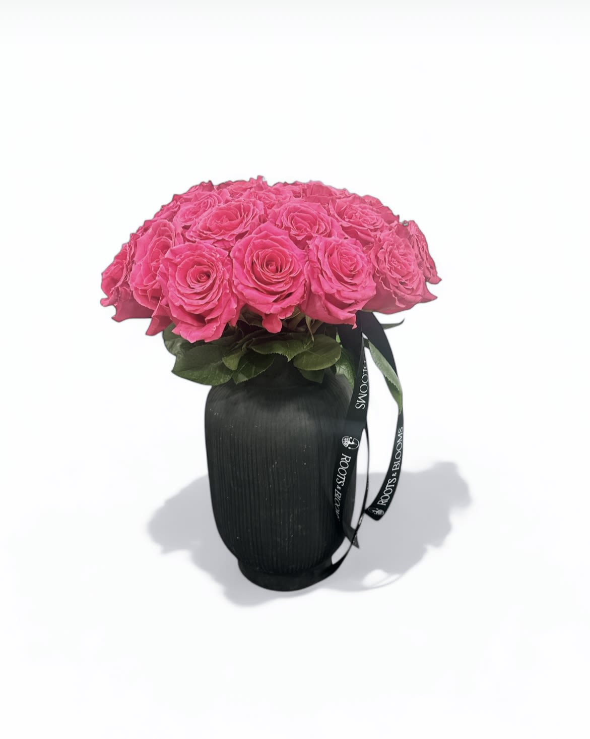 Rebel in Pink - Striking and modern, these vivid pink roses pop against a sleek black vase -an unforgettable blend of passion and edge.
