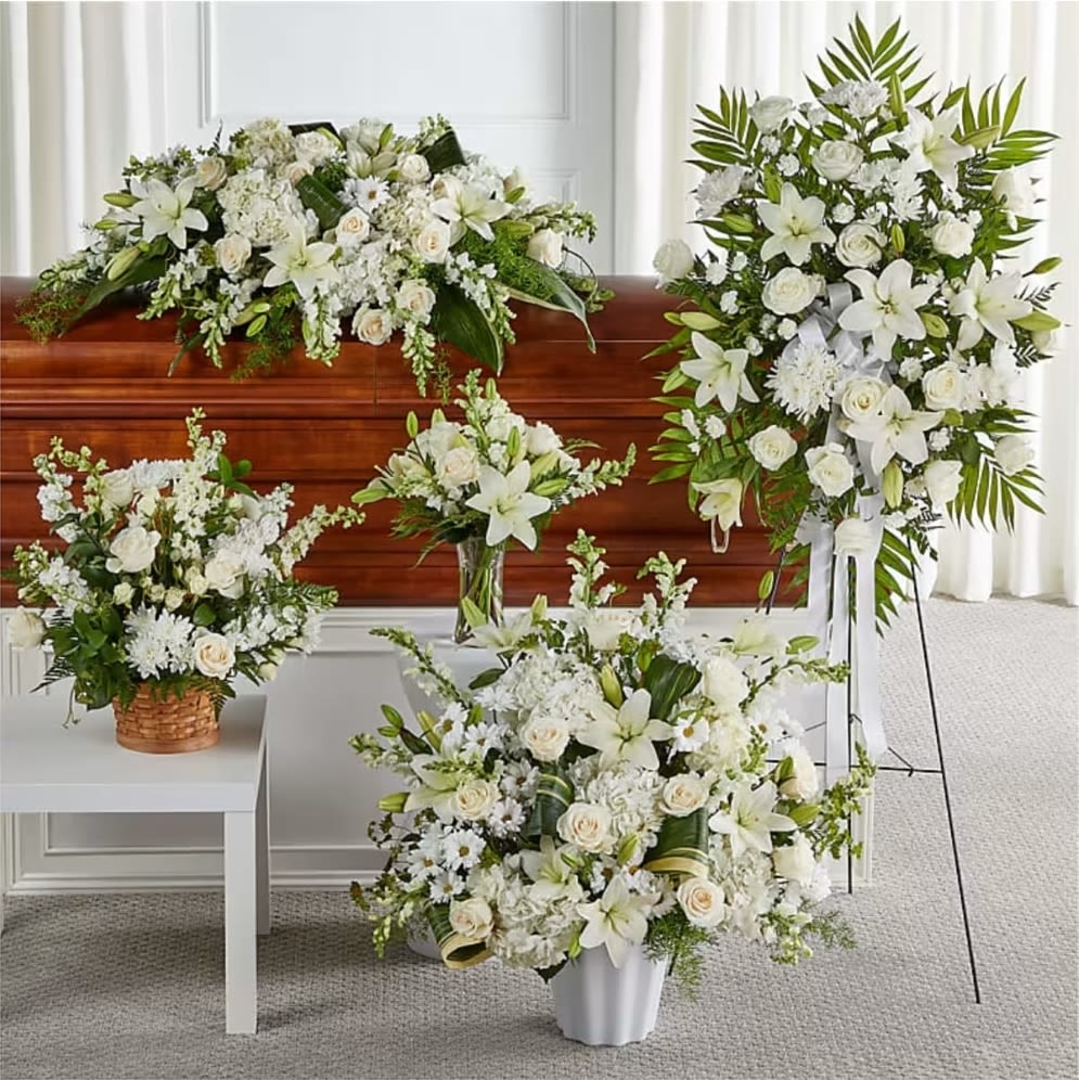 Sincerest Condolences Bundles - As part of our Touching Tribute Collection, this set, resplendent in classic whites, features traditional arrangements meant for celebrating the life of a loved one at a visitation, funeral, church service, cremation, or cemetery service – or as a delivery to the home of the family.  Please Note: The bouquet pictured reflects our original design for this product. While we always try to follow the color palette, we may replace stems to deliver the freshest bouquet possible, and we may sometimes need to use a different vase or basket. DETAILS  The Standard Bundle includes our Eternal Friendship Bouquet and Heartfelt Condolences Arrangement. The Deluxe Bundle includes our Eternal Friendship Bouquet, Heartfelt Condolences Arrangement, and Thoughts of Tranquility Floor Basket. The Premium Bundle includes our Eternal Friendship Bouquet, Heartfelt Condolences Arrangement, Thoughts of Tranquility Floor Basket, and Exquisite Tribute Standing Spray. The Exquisite Bundle includes our Eternal Friendship Bouquet, Heartfelt Condolences Arrangement, Thoughts of Tranquility Floor Basket, Exquisite Tribute Standing Spray, and Timeless Tribute Cremation Adornment or Abundance Casket Spray. Designed by florists, ready to display. For long–lasting blooms, add water daily. Pet Safety Precautions: This bouquet or plant may include flowers and foliage that are known to be toxic to pets. To keep them safe, be sure to keep this arrangement out of your pet's reach.