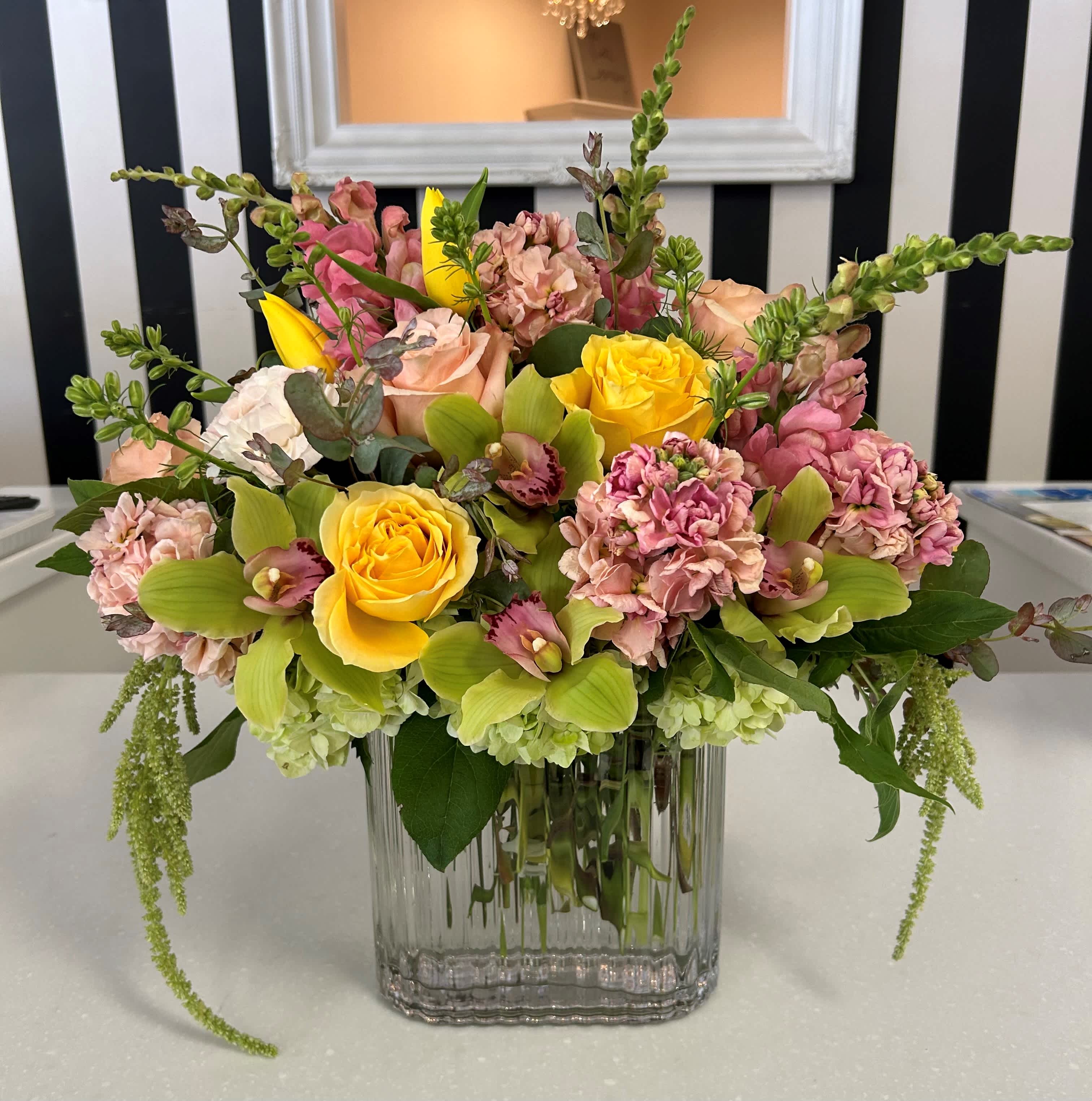 Summer Breeze Summer Breeze - This arrangement includes premium flowers in shades of yellows, greens and pinks in a glass vase.