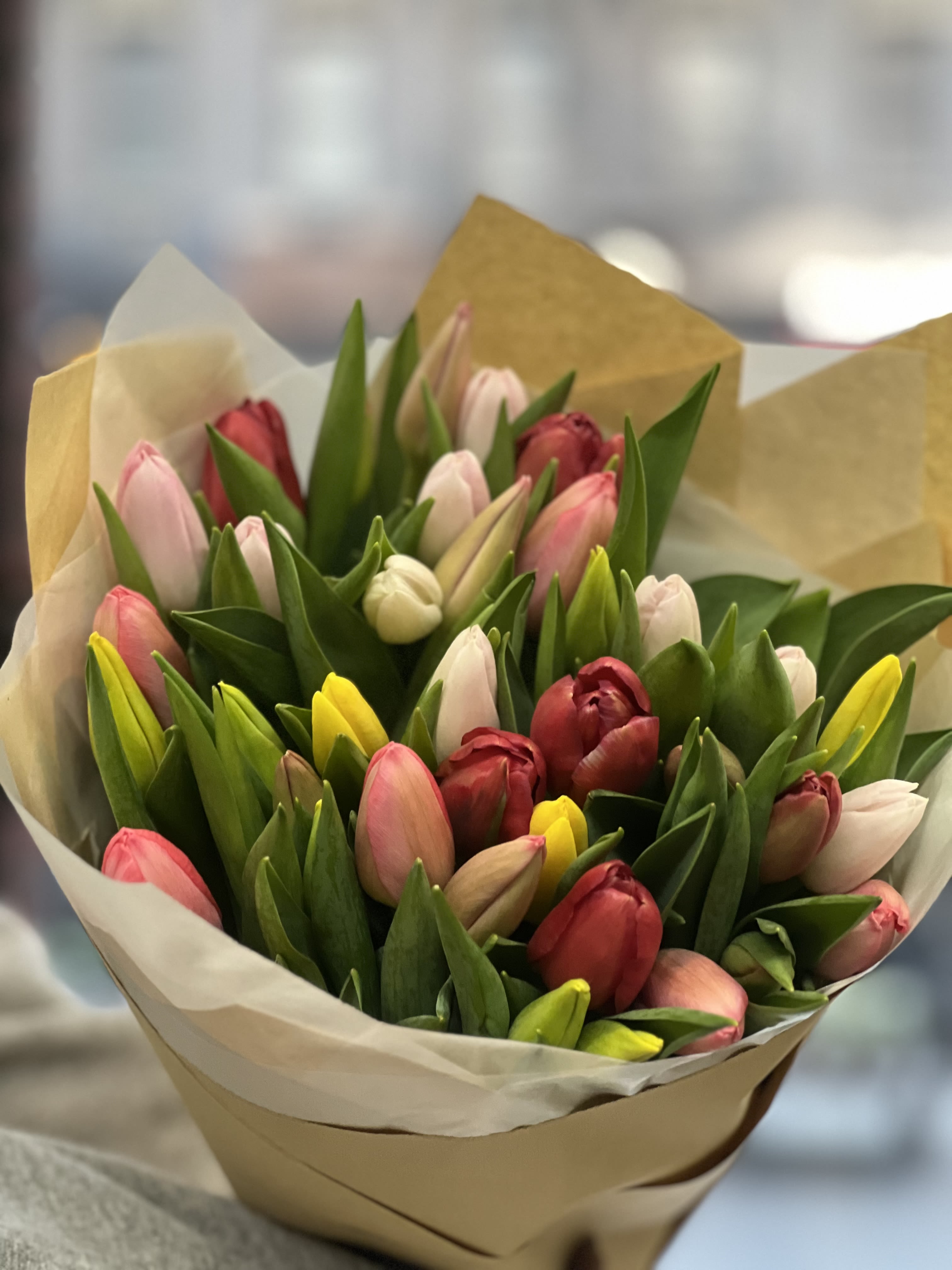 Tulip Garden  - This beautiful loose bouquet of tulips is a perfect blend of spring colors ready to brighten anyone’s day ! Please note: Vase not included. 