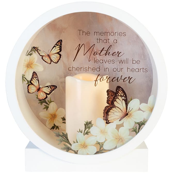 Mother Shadow Box Lantern - The shadow box lanterns consist of a built in flameless LED candle encased in a circular shadow box style lantern made with quality wood. The candle has a built in timer that runs for 6hrs ON and 18hrs OFF. 3 AAA batteries are not included. Indoor use only. W: 10&quot; H: 10.5&quot; D: 4.75&quot; Reads: &quot;The memories that a Mother leaves will be cherished in our hearts forever.&quot;