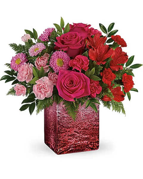 Teleflora's Breathtaking Ombre Bouquet - This ombre bouquet includes hot pink roses, red alstroemeria, hot pink miniature carnations, light pink miniature carnations, pink matsumoto asters, huckleberry, and leatherleaf fern. Delivered in an Ooh La Ombre cube.  Make them go &quot;ohhhh!&quot; with this amazing ombre gift, featuring a breathtaking spectrum of pink blooms in a shimmering distressed mercury glass cube with unique ombre shading.
