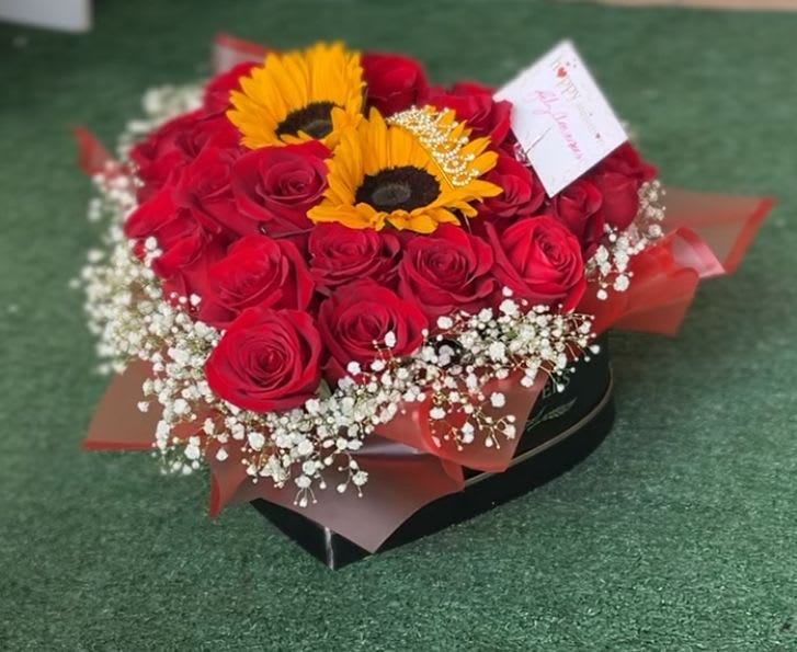 to my love - double dozen premium Ecuadorian roses surrounded by gypsophillia, 2 sunflowers in the center, and a delicate crown in the center, all in a cute heart shaped box with a message &quot; flowers &quot; on the box