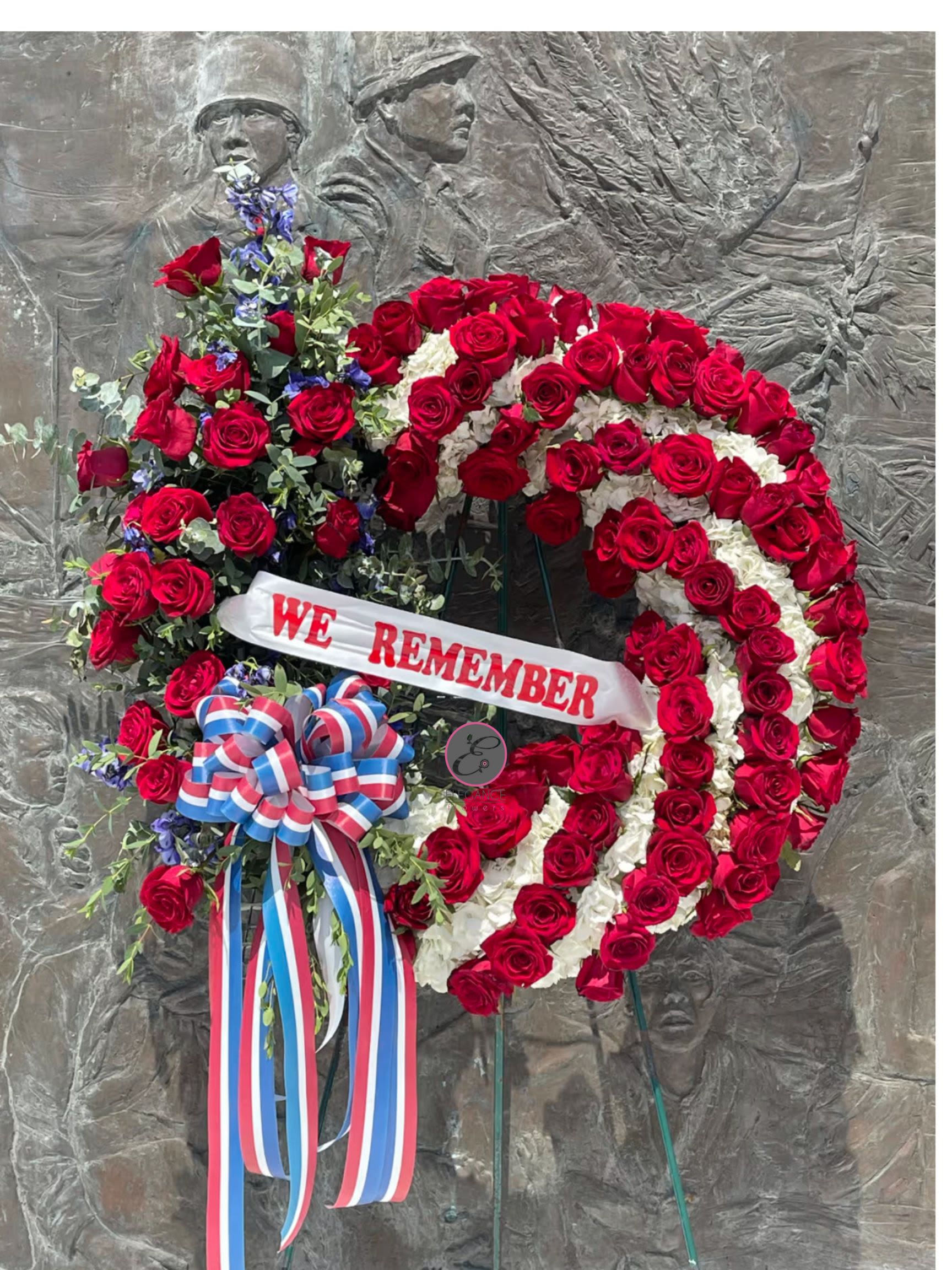 Patriotic Wreath Patriotic Wreath - A standing wreath is a circular floral arrangement, often used in funerals and memorial services. Its circular shape symbolizes eternal life, continuity, and the cyclical nature of life. Standing wreaths are crafted from a variety of flowers and greenery. They can be customized with ribbons, sashes, or personalized messages.