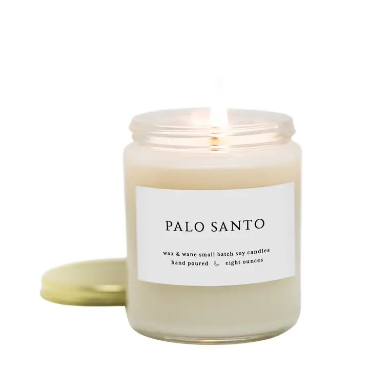 Wax + Wane Palo Santo Candle - Native to the rainforest of Ecuador and Peru- the wood and resin from Palo Santo has been used for centuries to help decrease stress and clear negative energy.  This candle does just that with a woodsy scent of Palo Santo combined with hints of patchouli, black pepper, white sage, and oakmoss. This candle feels like a hug and is a custom blend that took years to perfect.   Hand-poured soy candle in an 8 oz. glass mason jar. Candle is three inches in diameter &amp; burns for 50+ hours.   Each Wax &amp; Wane candle is lovingly made in small batches from soy wax derived from 100% American grown soybeans. We use cotton braided wicks that are lead &amp; zinc free, creating a clean, environmentally friendly burn. Our candles are always phthalate free &amp; made with premium grade essential oils &amp; fragrance.