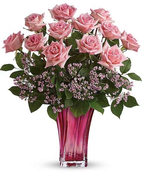 Teleflora's Glorious You Bouquet - Perfectly pink! Beautifully simple, this exquisite mix of soft pink roses and delicate pink waxflower finds its perfect complement in a fabulously fuchsia blown glass vase. Hand-delivered for Mother's Day, it's a glorious surprise she'll never forget!  This beautiful bouquet spotlights pink roses with pink waxflower and lemon leaf. Delivered in a Bold Elegance vase.