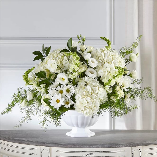 Love &amp; Compassion Arrangement - During times of sensitivity, remind those you care about that they are in your heart with our Love &amp; Compassion Arrangement. This display of elegant white flowers is hand crafted by our talented designers, ensuring your condolences are thoughtfully designed and delivered with care. DETAILS 23&quot;h x 32&quot;w