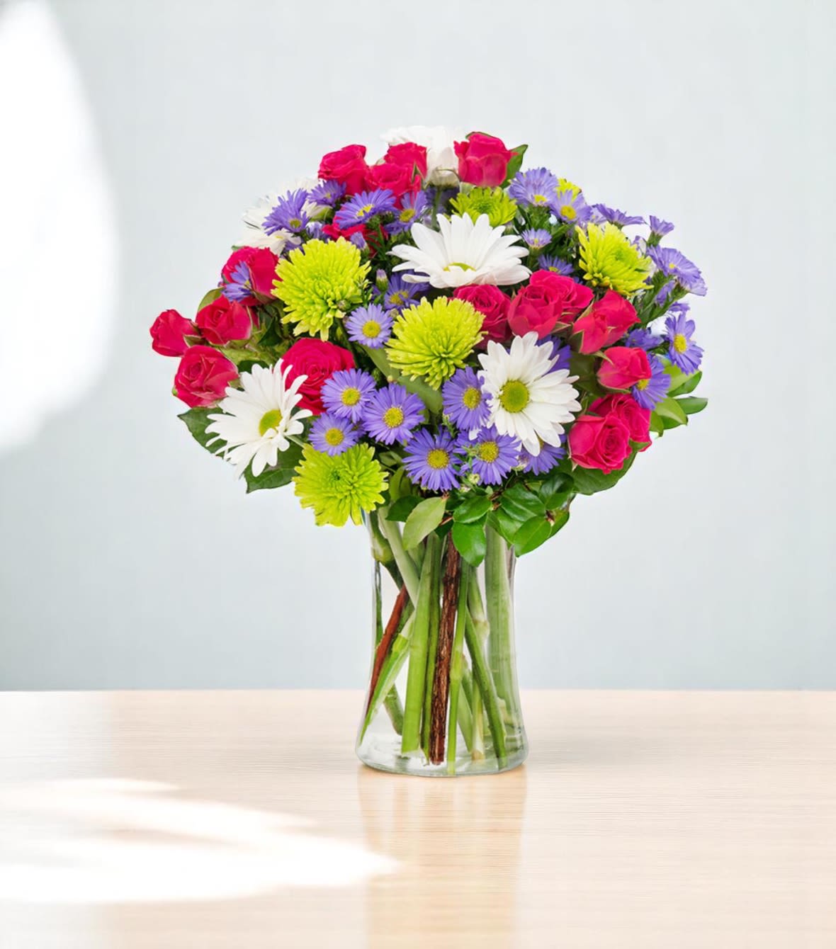 Cheerful Day - Send a gift that’s sure to make her smile. Handcrafted by our local florists, this bright bouquet is filled with a mix of blooms in hot pink, purple, green &amp; white. Get it delivered the same day for an instant dose of Mother’s Day cheer.