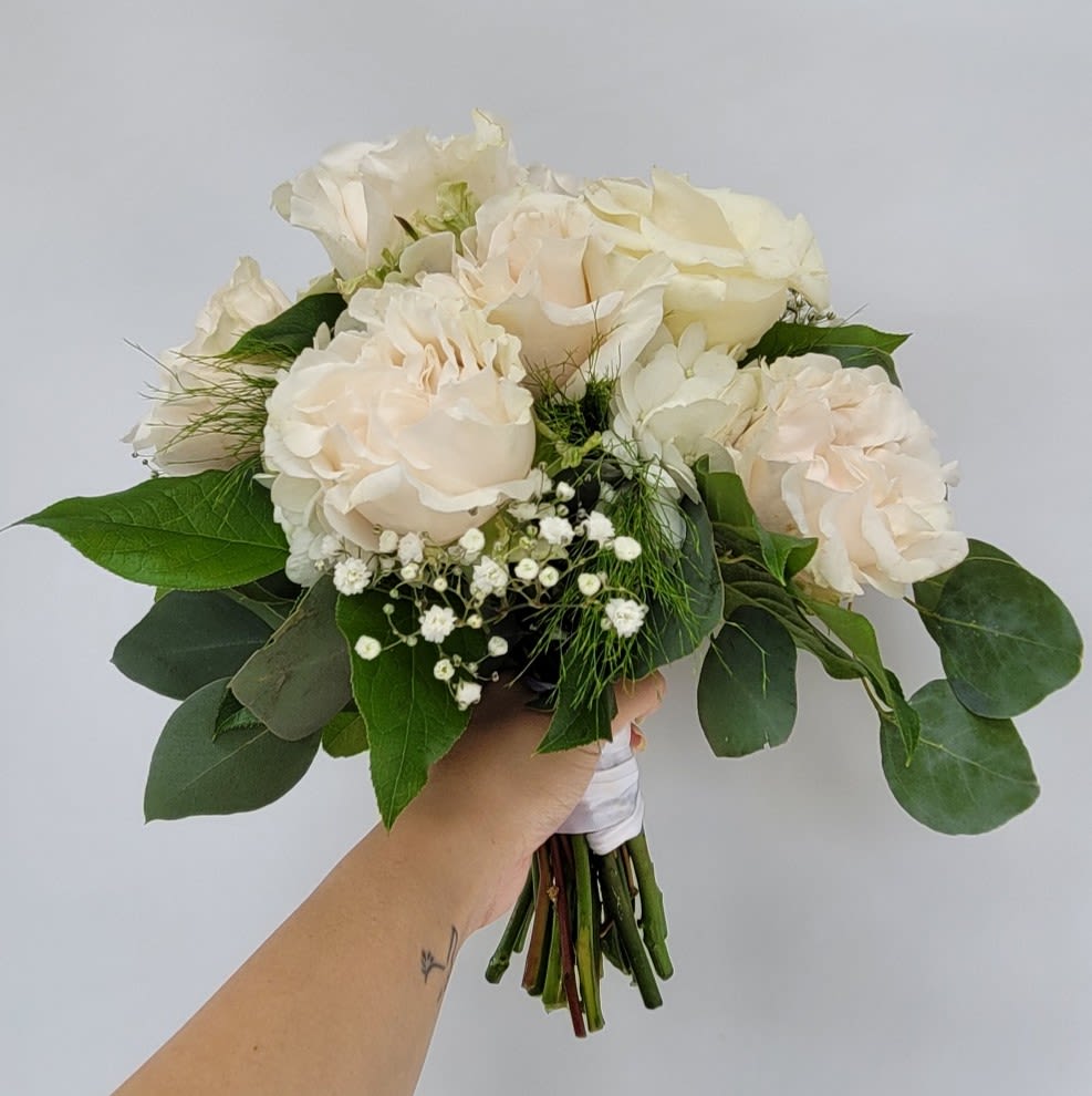 Nosegay with Garden Roses - Elevate your cherished moments with our exquisite Nosegay featuring blush garden roses. This hand-held bouquet is a timeless masterpiece, designed to complement life’s most memorable occasions. Whether it’s a prom, homecoming dance, recital, or wedding, this arrangement exudes elegance and grace, making it the perfect accessory for your special day. **Features: Premium blush garden roses, celebrated for their lush petals and romantic charm. Hand-tied design for a classic, sophisticated look. Versatile for formal events, from weddings to milestone celebrations. **Benefits: Adds a touch of timeless beauty to your ensemble. Customizable to suit your event’s theme or color palette. Handcrafted with care to ensure freshness and quality. Our designers may make substitutions due to seasonal availability, but rest assured, the bouquet’s style, theme, and value will always be preserved. Perfect for gifting or personal use, this nosegay is a celebration of nature’s artistry. Order now to make your event unforgettable with the delicate allure of blush garden roses.