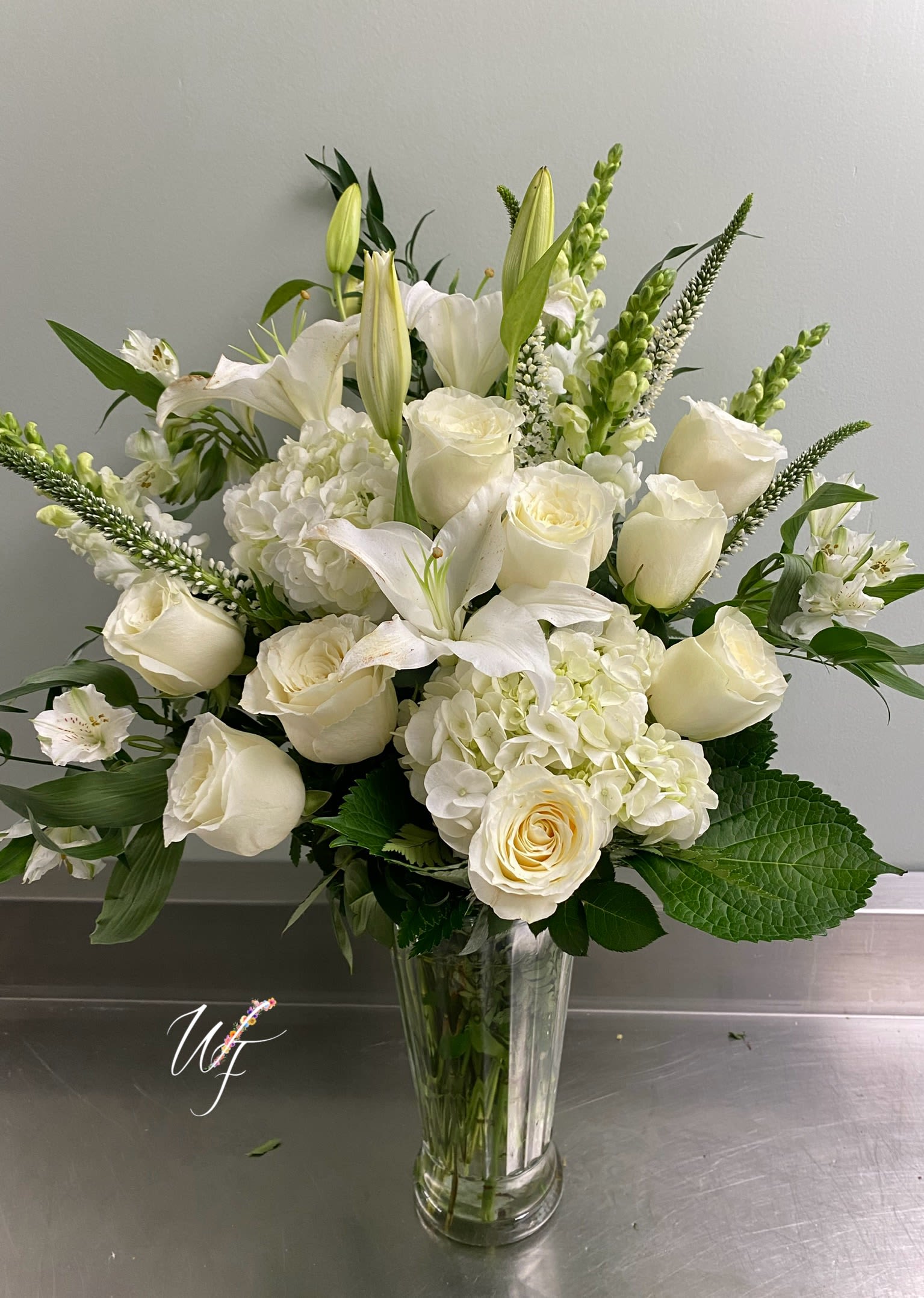 Divine Light - White premium florals displayed in a glass vase for a peaceful sentiment 