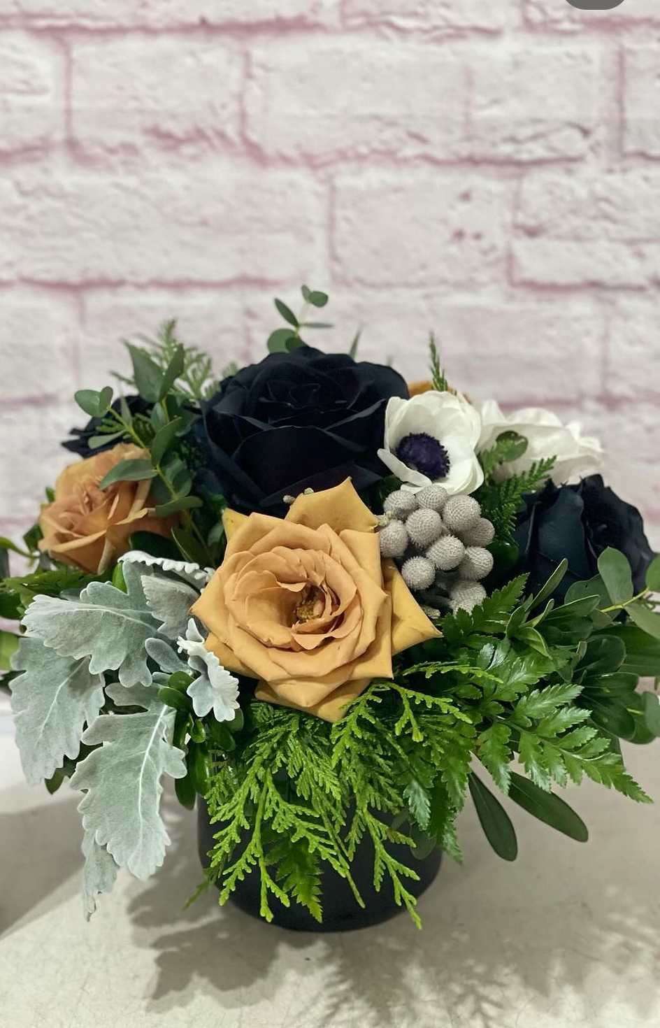 Black Tie Affair Black Tie Affair - A sophisticated bouquet of blooms arranged in a black or smoke glass vase. Perfect for a masculine valentine or for anyone that loves the tabacco, leather and cognac vibe.
