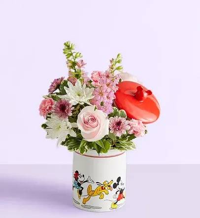 Disney Mickey Mouse &amp; Friends Cookie Jar-Baby Girl - EXCLUSIVE Welcome the little princess with a gift full of character(s)! Part of our new Disney collection, this handcrafted bouquet is gathered in sweet pink and lavender blooms and designed in our whimsical Mickey Mouse and Friends cookie jar, featuring iconic animations. Great as a keepsake container or for keeping treats, it’s an adorable way to celebrate the littlest Disney fan and family.  All-around arrangement with pink roses, mini carnations and larkspur, lavender button poms and white cushion poms; accented with assorted greenery Artistically designed in our exclusive Mickey Mouse and Friends Cookie Jar; food safe container that can be used as a keepsake or for any type of treat once the flowers have expired; measures 7.5&quot;H x 4.5&quot;D