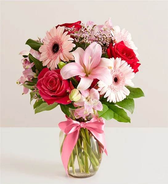 FOE Romance  - Inspired by the rich beauty of the European countryside, our romantic bouquet reveals all the feelings you have in your heart. Fresh-picked pink &amp; red blooms are on display inside a glass vase finished with ribbon, creating a timeless gift for someone you love.
