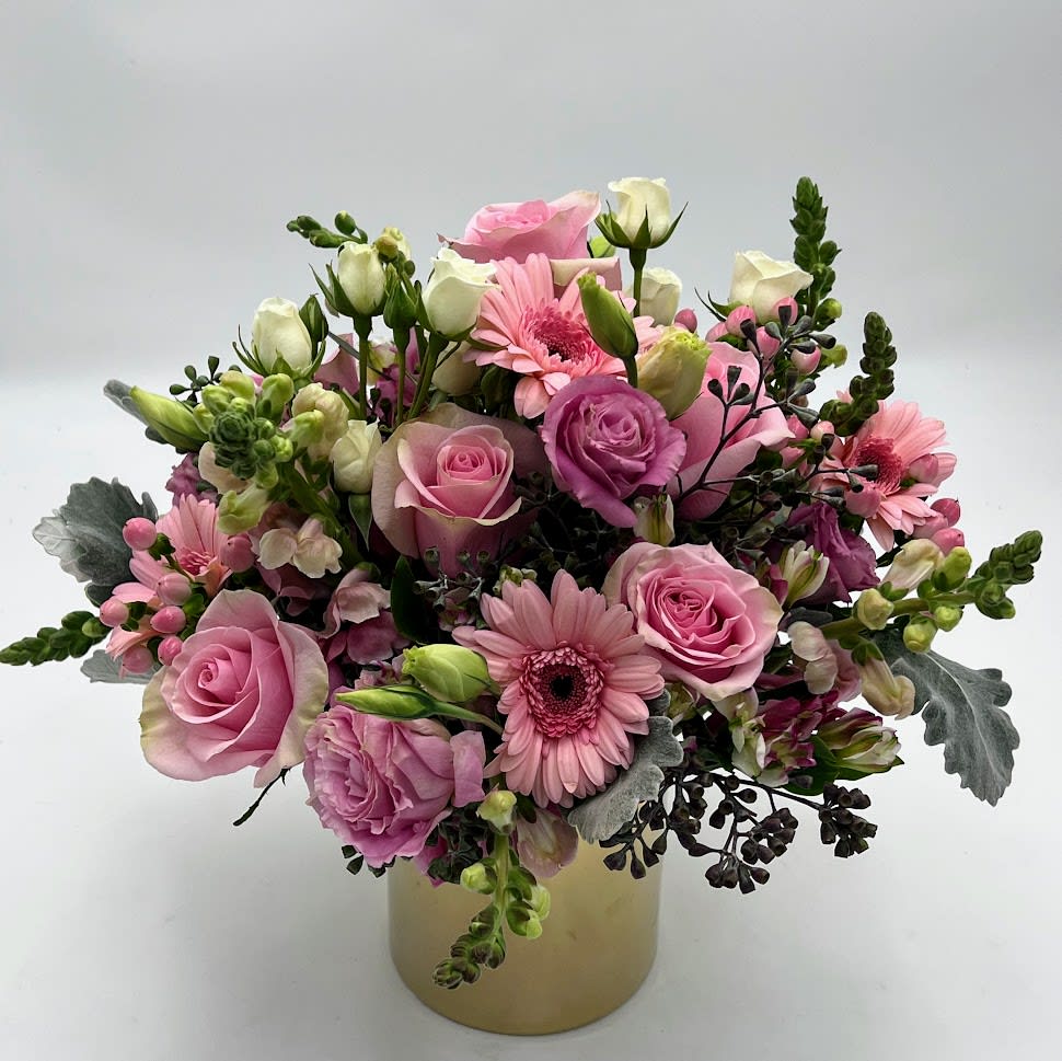 Linda  - It's pink and it's scented, which gives it a little something extra. This bouquet is A Delicate arrangement with different tones of pinks and peach arranged in a gold cylinder vase. You can't object to this chic arrangement, your loved ones will doing the bend and snap over receiving this.