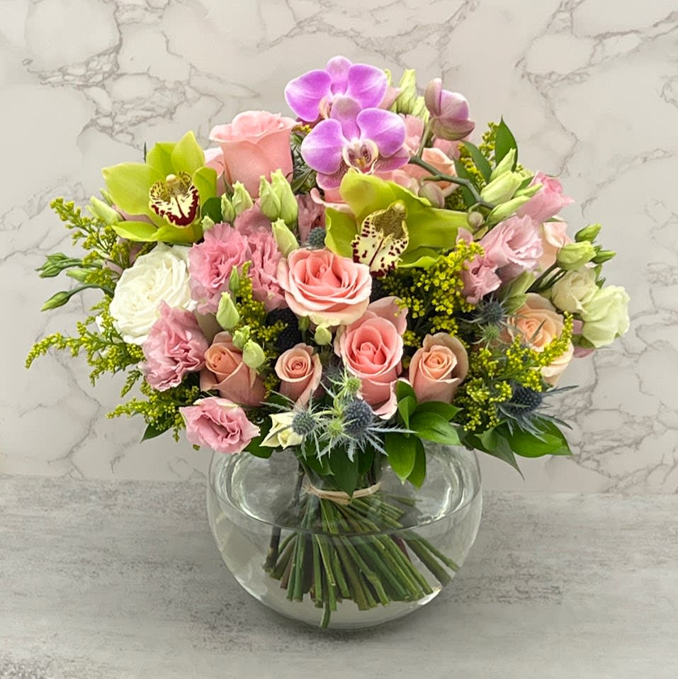 Paradise - perfectly arranged flowers to capture the beauty of freshly hand-picked flowers from the garden, with baby pink delicate Roses, Lisianthus, Cymbidium luxury orchids, the unique eryngium flower, and Solidago