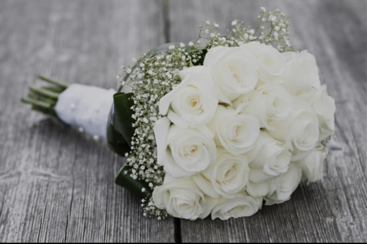 Handheld White Rose Bridal Bouquet Handheld White Rose Bridal Bouquet - 18 white roses with a ring of baby's breath, greens, and ribbon wrapped stems