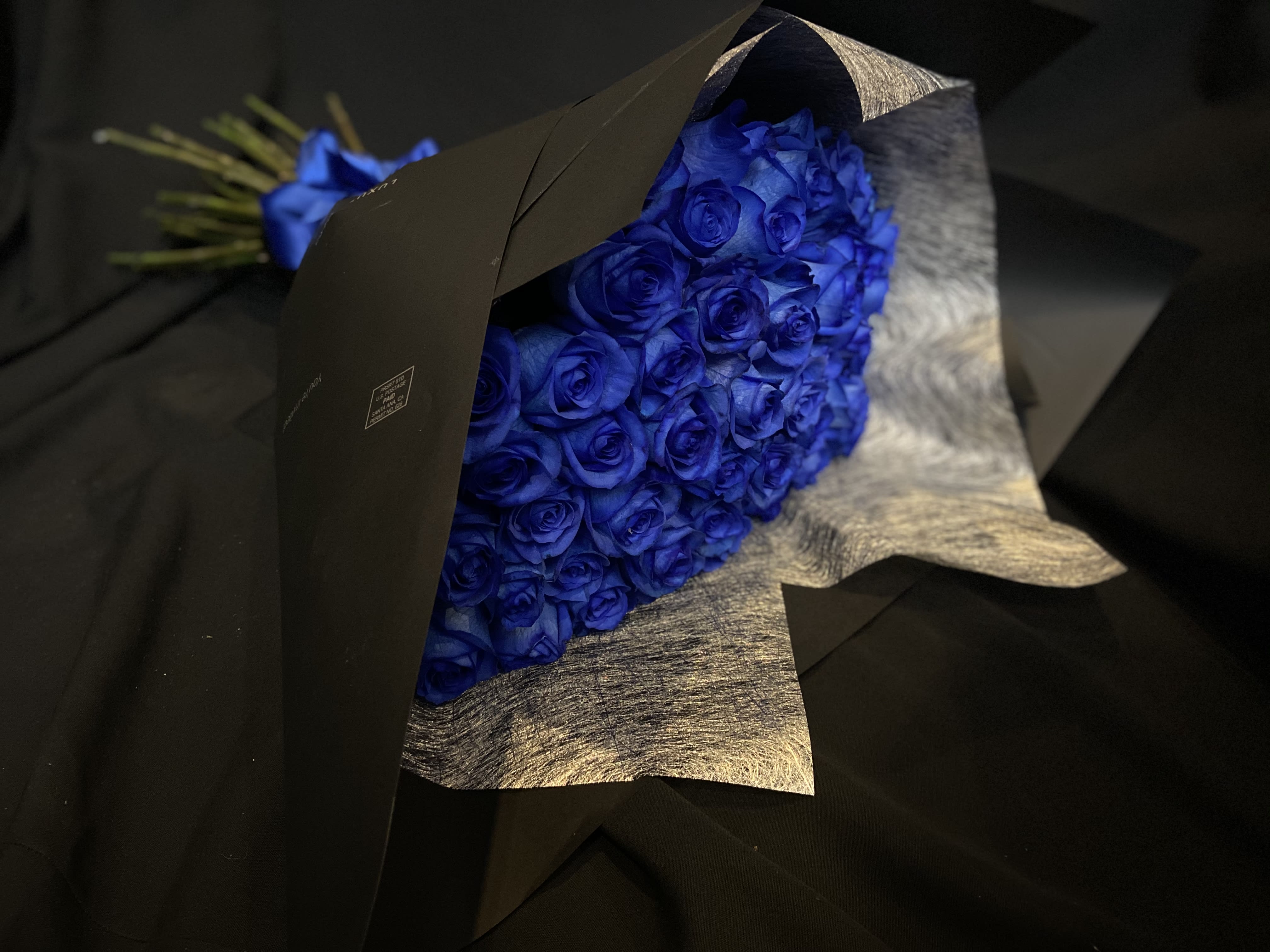 Blue Rose Bouquet 24 - 2 Dozen Blue Roses Wrapped with Black Paper and Blue Ribbon.