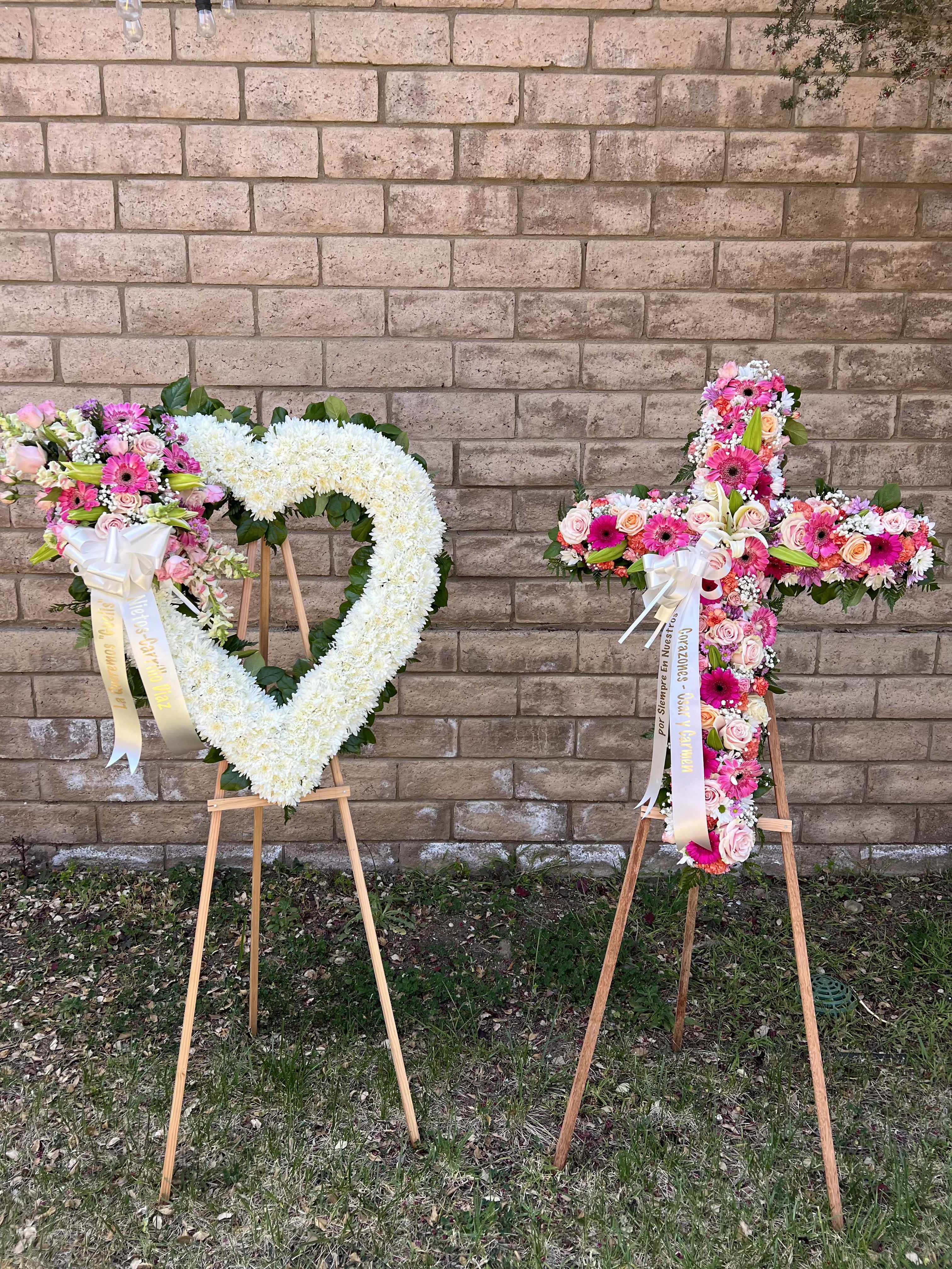 Set Of Two Set Of Two - Set Of Two Heart-shaped Wreath and a Cross-colors Heart Shape Wreath- represent love and affection the heart is universal symbol of love. Often used to honor a spouse, parent, child, or someone deeply cherished. express deep sorrow and empathy for the loss. Cross- represent faith, salvation, and reverence, Spirituality, Christianity, eternal life. Cross and Hearth Set displayed together carries a deep, layered message of Love, Faith, and eternal remembrance. here's what they represent as a set together, they express: "we love you deeply, and we entrust you to God's eternal Care.
