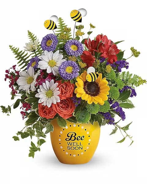 Teleflora's Garden Of Wellness Bouquet - Boost their spirits and brighten their day with this garden of wellness! Hand-delivered in a sweet ceramic &quot;Bee Well Soon&quot; pot, this colorful arrangement of roses, alstroemeria and asters is abuzz with delightful bee decorations - and your very best wishes for a speedy recovery.  Includes orange spray roses, red alstroemeria, lavender matsumoto asters, yellow sunflowers, green button mums, white daisies, purple statice, pink sweet william, bupleurum, sword fern, leatherleaf fern, variegated pittosporum and ivy. Delivered in a Buzzing Bee Well pot.
