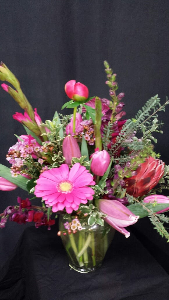 Passionate Pink Mix by Gregory and Company Passionate Pink Mix by Gregory and Company - A pleasing mix of our highest quality seasonal pink blossoms beautifully arranged with premium greens.
