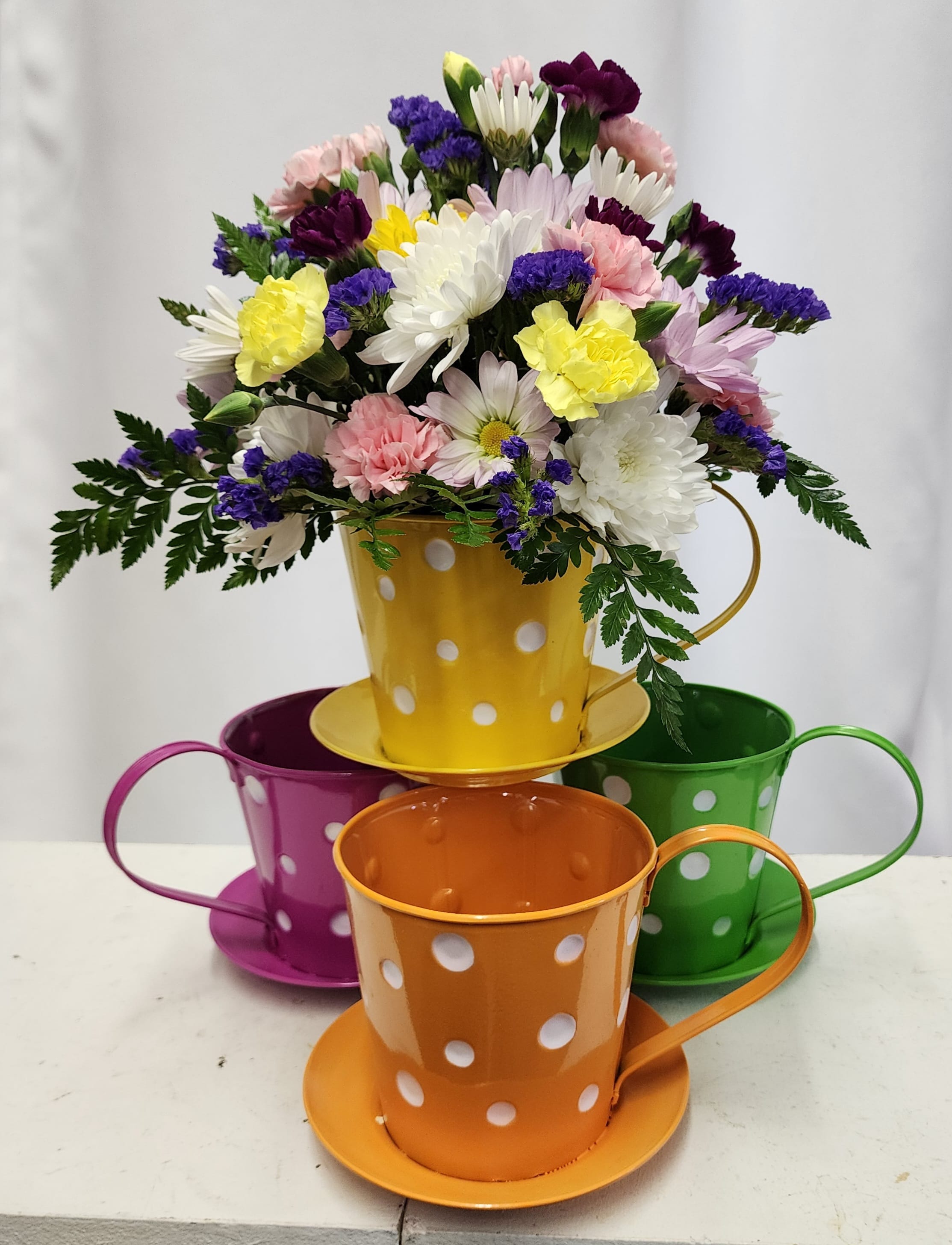 Cup of Joy! - A colorful cup of blooms to make anyone smile.  Limited quantities available. Note your preferred color choice in the notes to florist. Substitutions will be made based on availability. Available in 4 colors shown. Price is per cup. 