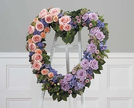 Hearts Of Color -E13 Hearts Of Color -E13 - If you want to send a message of hope, this lovely open heart spray with its pink and purple roses and hyparicum berry sends it harmoniously.