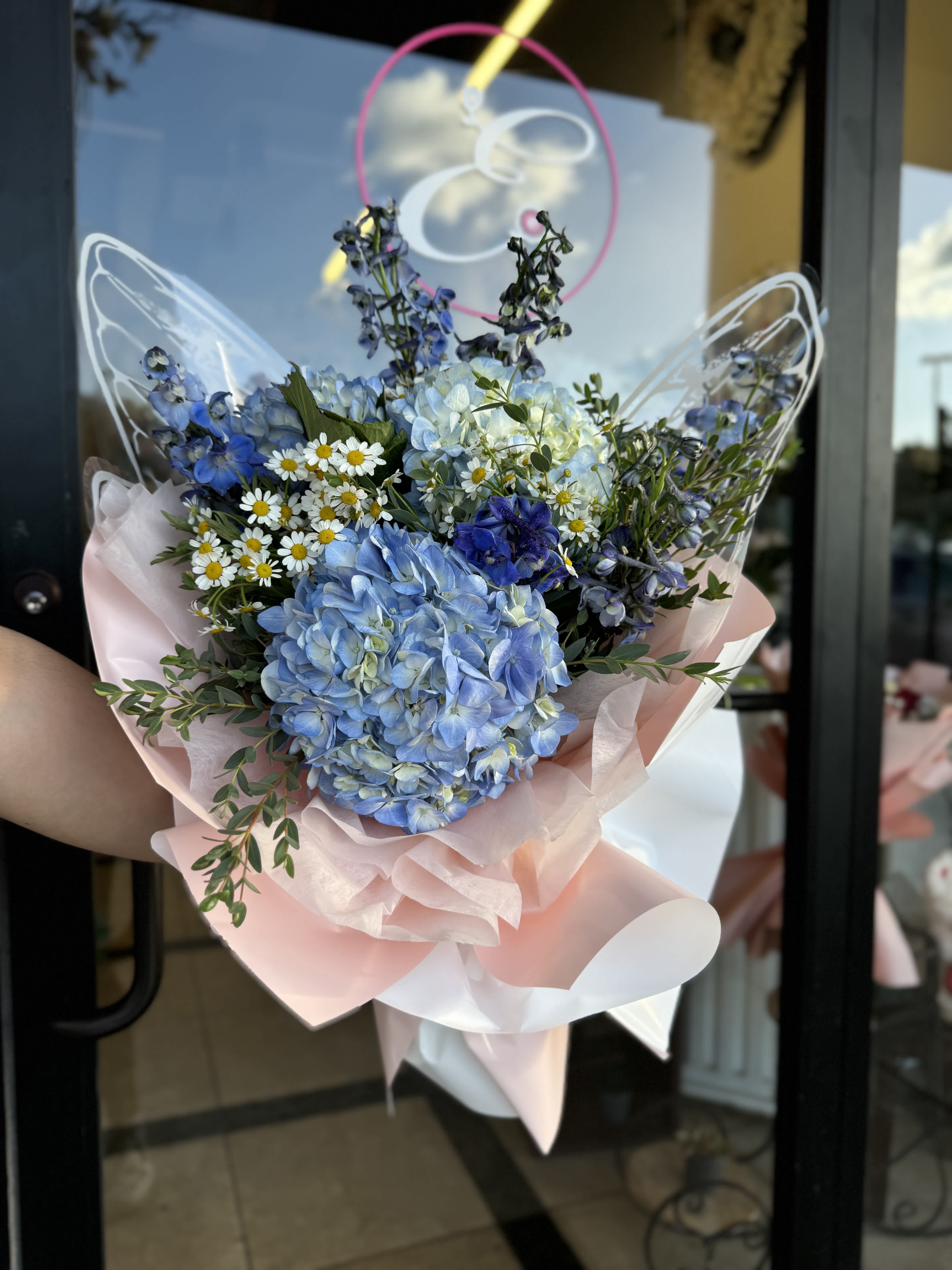Wrapped Bouquet #4 Wrapped Bouquet #4 - A wrapped bouquet of flowers is a beautifully arranged collection of blooms, carefully selected and elegantly wrapped in decorative paper or fabric. These bouquets often feature a mix of fresh, vibrant flowers, complemented by lush greenery, and are tied together with a ribbon or twine. Wrapped bouquets are perfect for any occasion, from expressing love and gratitude to celebrating special moments, offering a thoughtful and visually stunning gift.