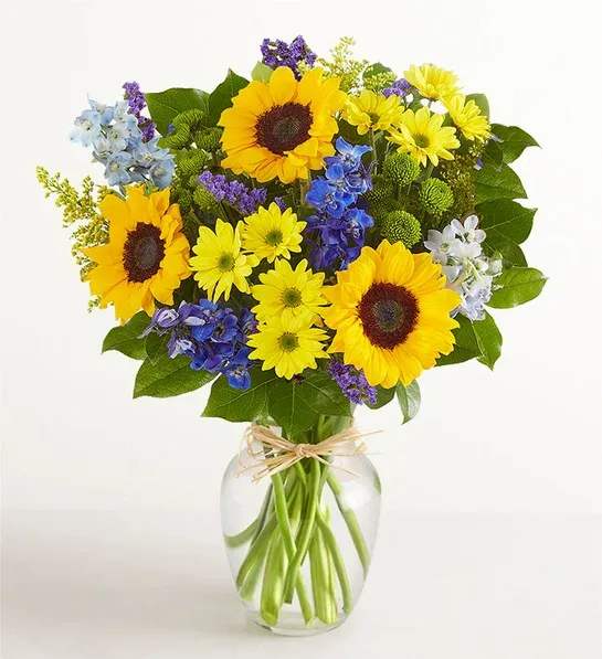 Summer Sun Summer Sun - This beautiful bouquet is the perfect splash of color. A gorgeous array of sunflowers, delphinium, and daises. This bouquet is sure to bring a smile.