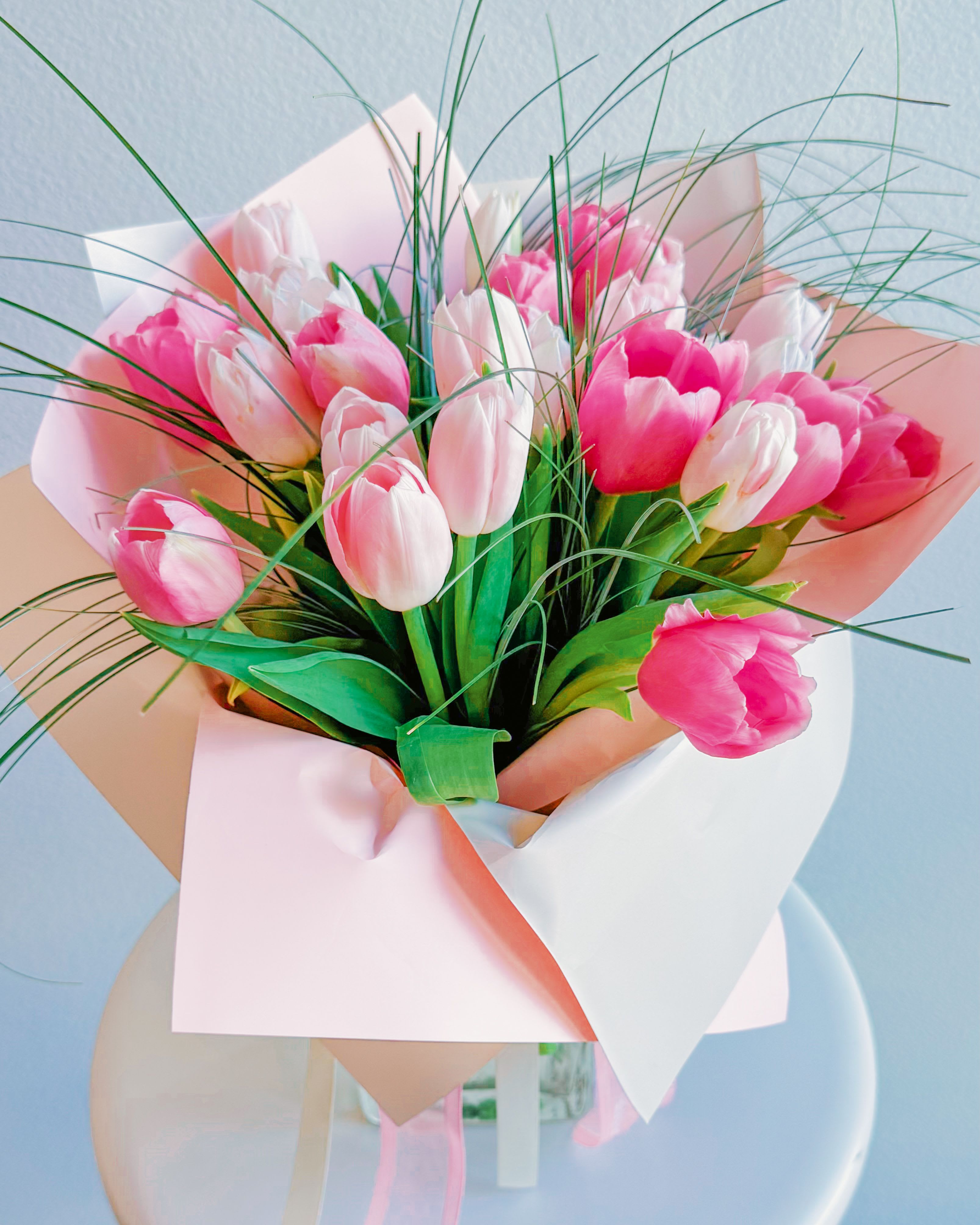 Pretty in Pastels - This bouquet is a gentle whisper of love and tenderness. The delicate tulips in shades of soft pink and vibrant magenta radiate pure emotion, evoking the first blush of romance or the warm embrace of cherished memories. Wrapped in pastel tones and complemented by wispy greenery, it feels like holding a spring meadow kissed by the morning sun. The bouquet consists of 30 tulips. At your request, the bouquet can be enlarged with the addition of more flowers.  Occasions for Gifting: Romantic gestures: anniversaries, Valentine’s Day, or “just because” moments to say “I love you” Celebrations of joy: birthdays, baby showers, or spring festivities Special milestones: graduations, engagements, or housewarming gifts Simple acts of kindness: a thoughtful surprise for someone special 