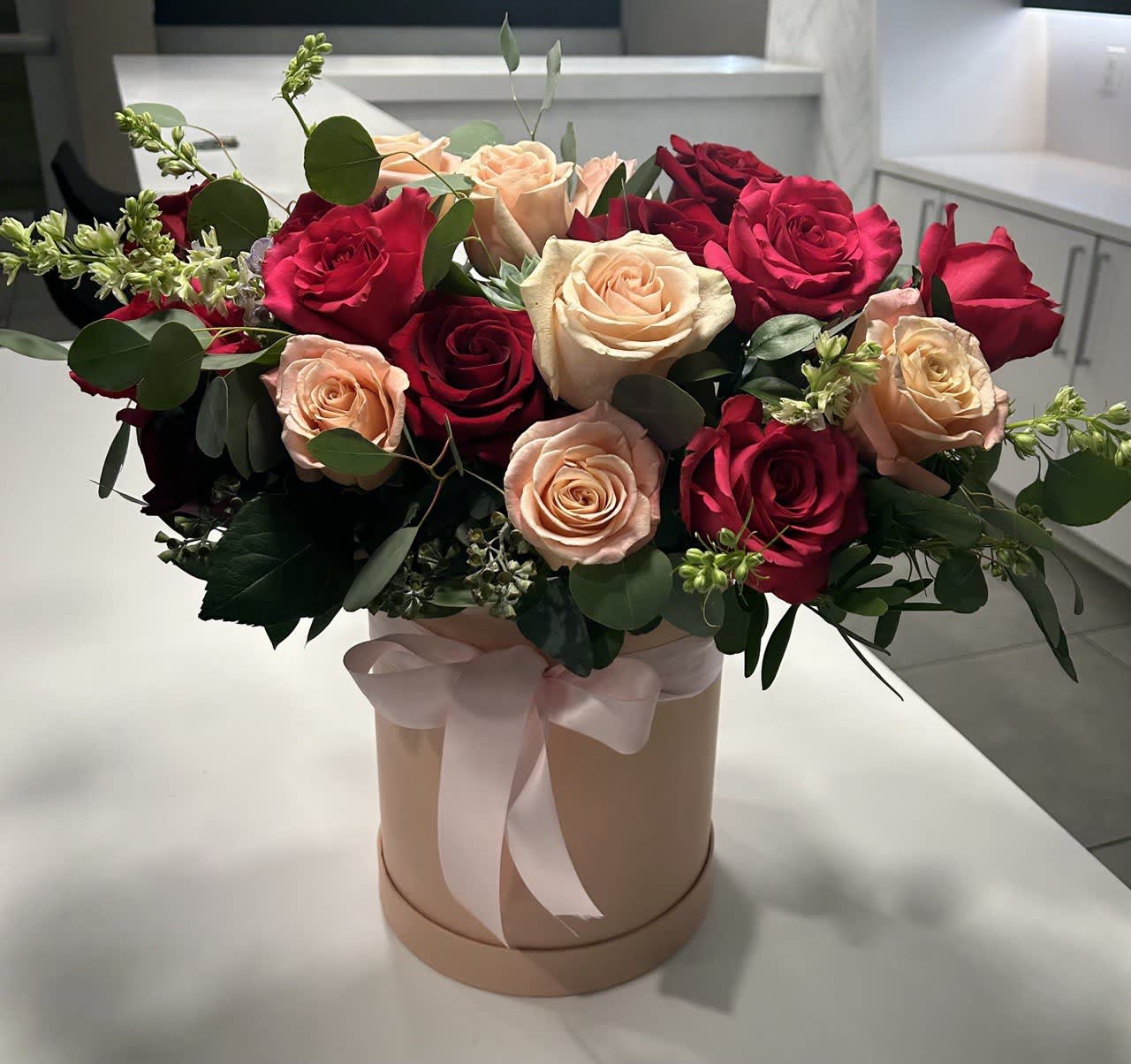 Charm Charm - The bouquet includes roses in shades of pink and red. Roses are timeless symbols of love, beauty, and passion. The pink roses convey admiration and gratitude, while the red ones symbolize romantic love.
