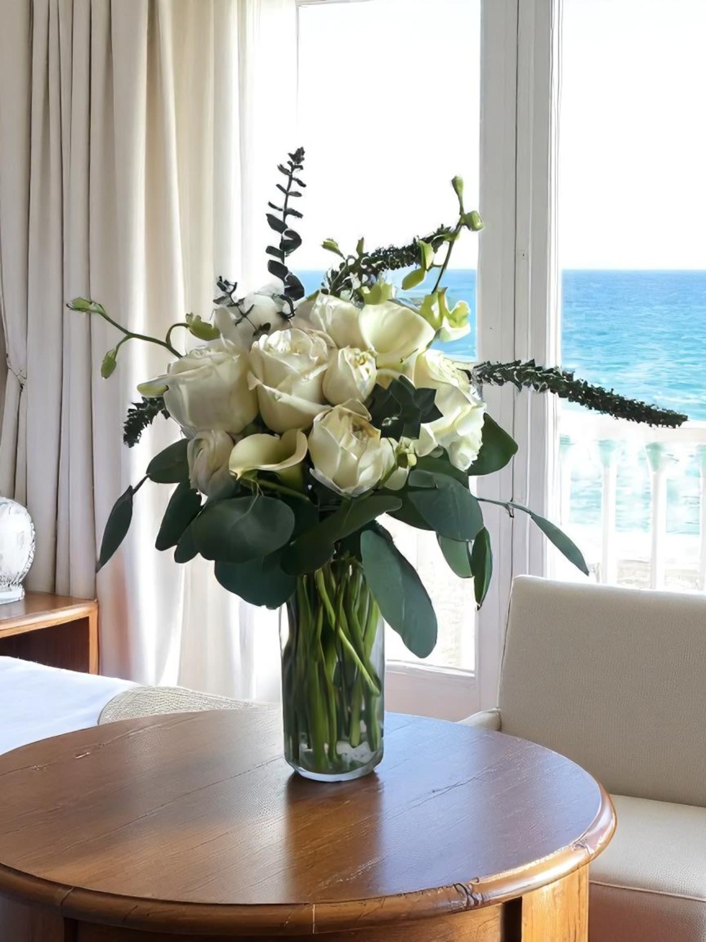 Always Flowers - Because her love is your constant — calm, strong, and always there. Introducing Always Mom  — a timeless and refined floral arrangement that celebrates the enduring presence and quiet strength of a mother’s love.  This elegant composition features a serene blend of creamy white roses, ranunculus, mini callas, and orchids, complemented by fresh eucalyptus and veronica. Arranged in a tall, minimalist glass vase, the design conveys purity, grace, and a lasting emotional connection.  Sophisticated in its simplicity, Always Mom is a heartfelt floral tribute — perfect for honoring the one who’s always been your steady light.    Dimensions: Height: 45 cm (18 inches) Width: 25 cm (10 inches)   Now available for pre-order with same-day delivery in Miami’s luxury districts.  #AlwaysMom #LuxuryFlorals #MothersDayGift #WhiteBlooms #ElegantFlowers #MiamiFlorist #ForeverLove 